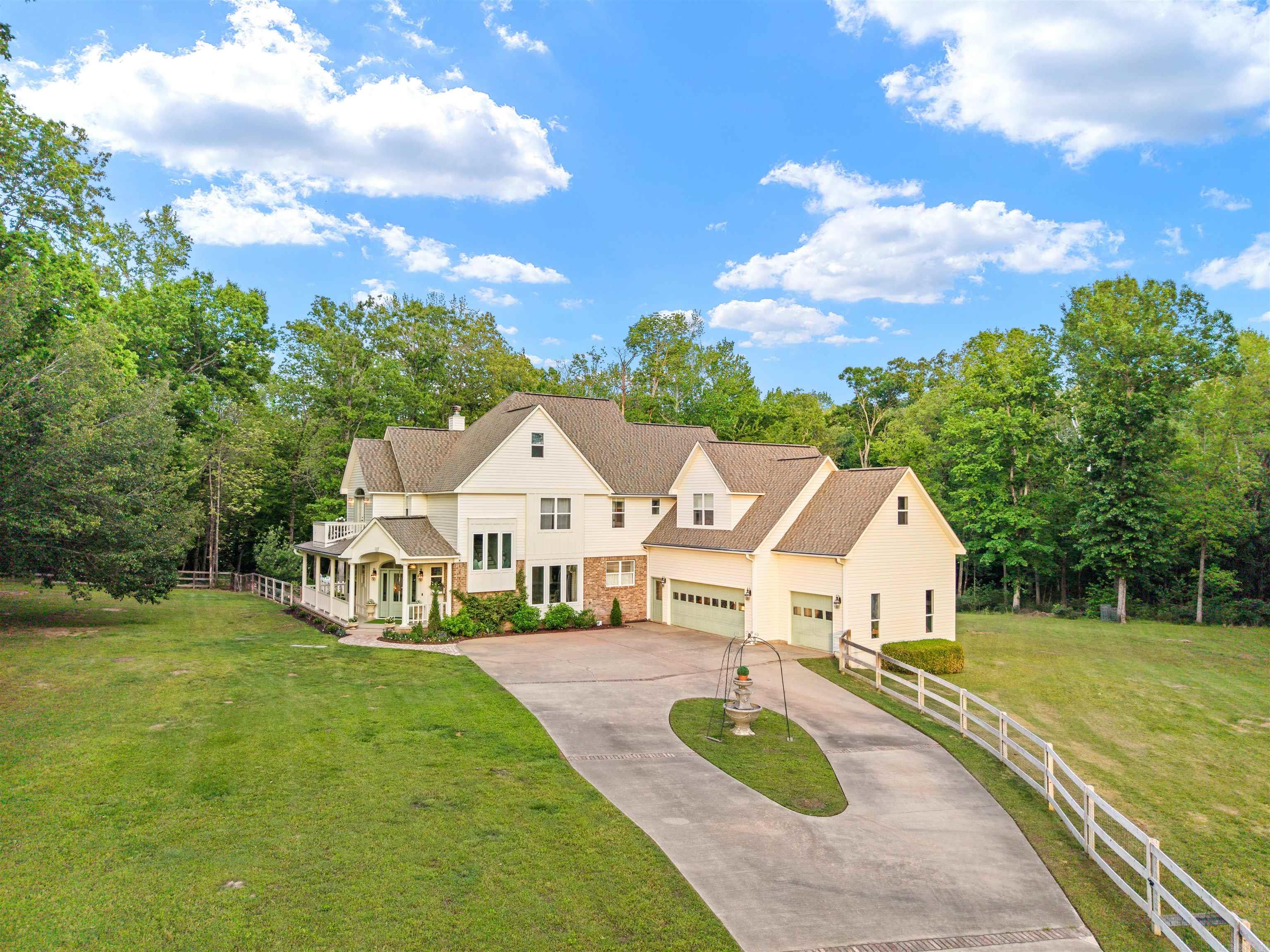 Full of character and timeless charm, this beautifully renovated home sits on 5 private acres—truly an oasis to come home to. This one-of-a-kind property features fresh paint, new flooring, crown molding, abundant natural light, and a thoughtfully designed floor plan with multiple living areas, including a spacious living room, hearth room with a double-sided fireplace, and bonus space. The kitchen offers granite countertops, ample cabinet space, and a layout ideal for both everyday living and entertaining. The primary suite is a true retreat with a private balcony overlooking the serene setting. Additional features include a Jack-and-Jill bath, well-sized secondary bedrooms, and a charming nook tucked beneath the staircase—perfect for storage, a reading space, or a fun hideaway. Step outside to your own backyard paradise with a newly added pool, expansive outdoor living space, and large deck—perfect for relaxing or hosting. The property is fenced and gated, offering both privacy and security, all tucked in a quiet cul-de-sac while still convenient to town. Enjoy the added touches of established apple and peach trees, a muscadine vine, sprinkler system, and a storm shelter located
