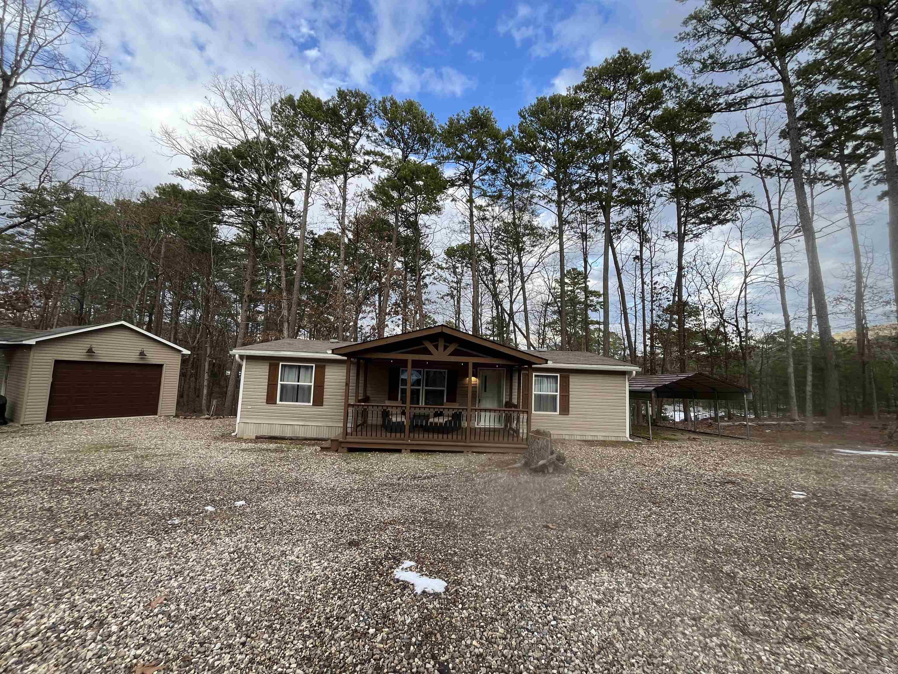 Super cute move in ready cozy place at Mountain Harbor! Minutes from the lake! This home is fully furnished just waiting on you to move in! 3 bedroom/2 bath, custom tile showers, back porched is optional to be screened or open for extra bonus room to entertain. 16X24 shop with garage door, fire pit, 12x24 covered carport! Lots of parking for guests with circle drive. This place is just waiting on you to come enjoy the lake!