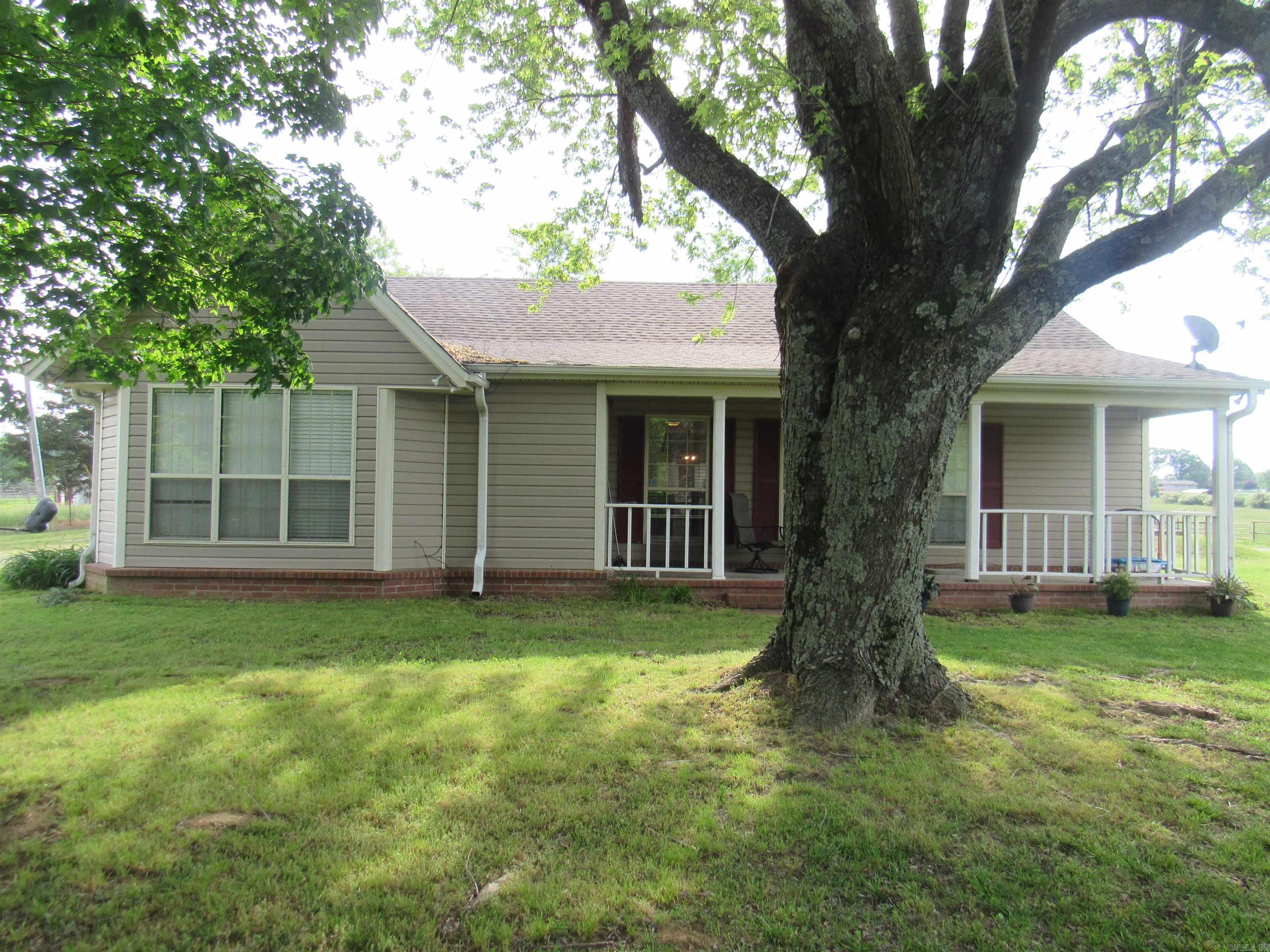 Beautiful home outside city limits. This home is move in ready and sellers are motivated! Home sits on half an acre lot while being surrounded by acreage. There is an additional 350 sqft bonus room with it's own heating and cooling system that is not included in the square footage.  Kitchen has been updated with Dolomite Volcanic Marble countertops. It features a pantry and brand new water heater. Fridge, washer and dryer all convey to new owner! Primary bedroom is huge, and as a bonus every bedroom has 2 closets. Laundry room/mud room conveniently opens out to the oversized carport.