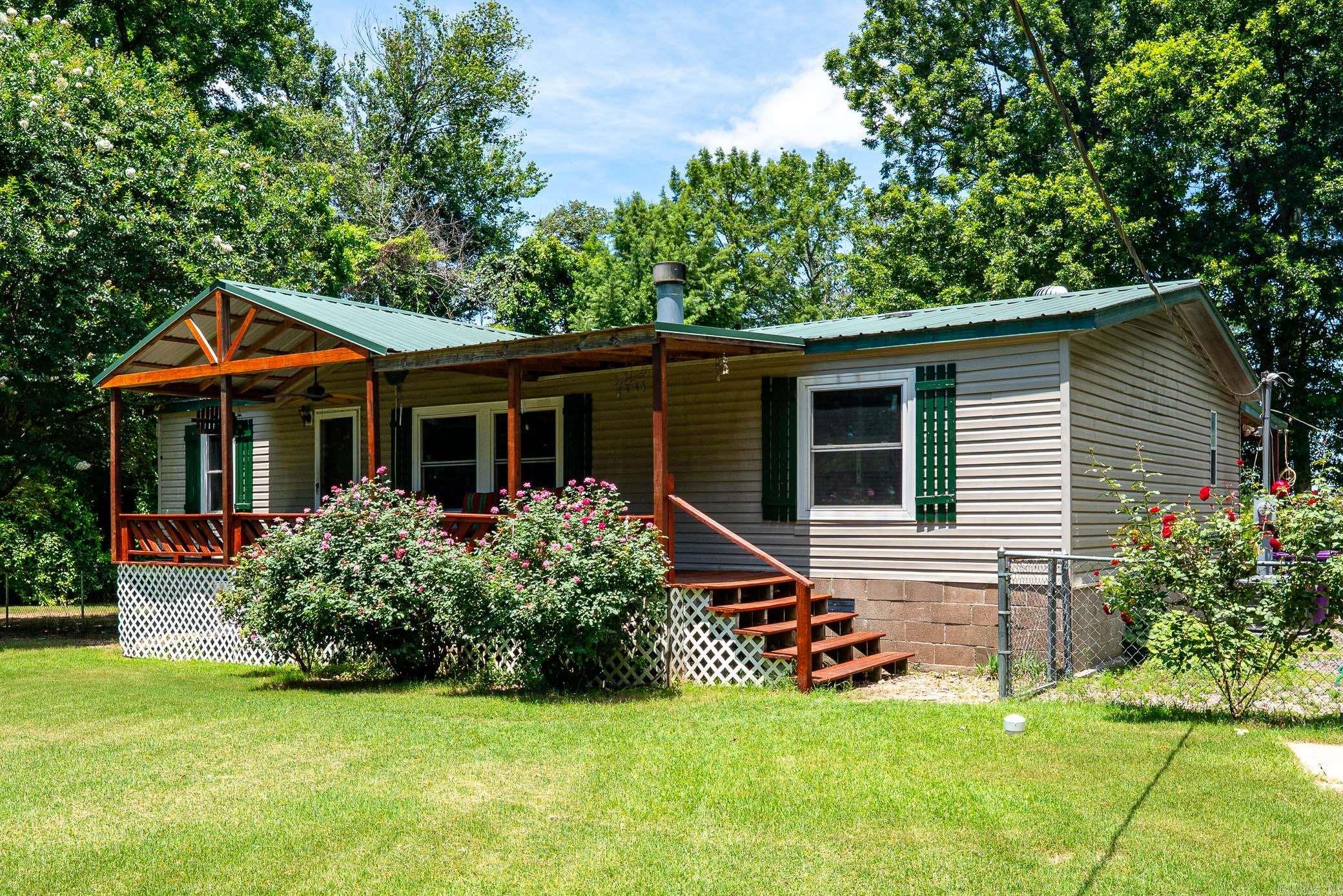 Enjoy lakefront living with this 3 bedroom, 2 bath home, sitting on 4 lots. The sunroom overlooks Lake Conway as does the 10.5 x 21 ft. deck to enjoy. Recent updates include 3 yrs. old dishwasher, along with an A/C, heat pump, new windows on the front of home all replaced 4 yrs. ago.  All appliances convey, ready for you to enjoy lake life.  The 3 additional lots are separated by Norman Lane.  All lots are Lakefront property. See documents for plat. Seller has never occupied the home, so there is no Seller Property Disclosure.  See Agent Remarks.
