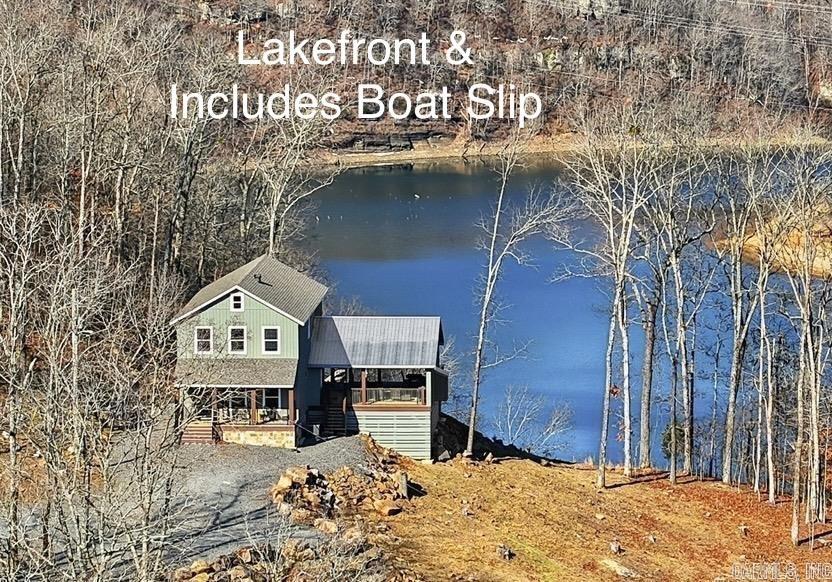 This Property checks a lot of boxes ..*BOAT SLIP *LAKEFRONT *PANORAMIC LAKE VIEWS *Newly Built Home *ACREAGE w/6.91 ACRES!!!! Great Location with Boat Slip in the Watersedge Community Dock (Slip #12) located in a protected cove off of Middle Fork on Greers Ferry Lake with easy access from the dock parking lot. Your guests will be Amazed as they pull up to park & immediately see the Gorgeous Views! It never gets old driving up to this home as you wind through the trees up the driveway & then the views open up as you pull up to the Lake House! Main bedroom on first floor w/ 3 other bedrooms upstairs off of the Gameroom (that also has lake views). Hand scraped 3/4" Solid hickory wood floors thoughout the home. Main level has an open kitchen/living room combo with more lake and mountain views plus walkout door onto the 24x32 covered porch w/gas fireplace (gas logs not present) where you can unwind from a day on the lake. (SEE LINKS FOR VIRTUAL TOUR AND VIDEO)