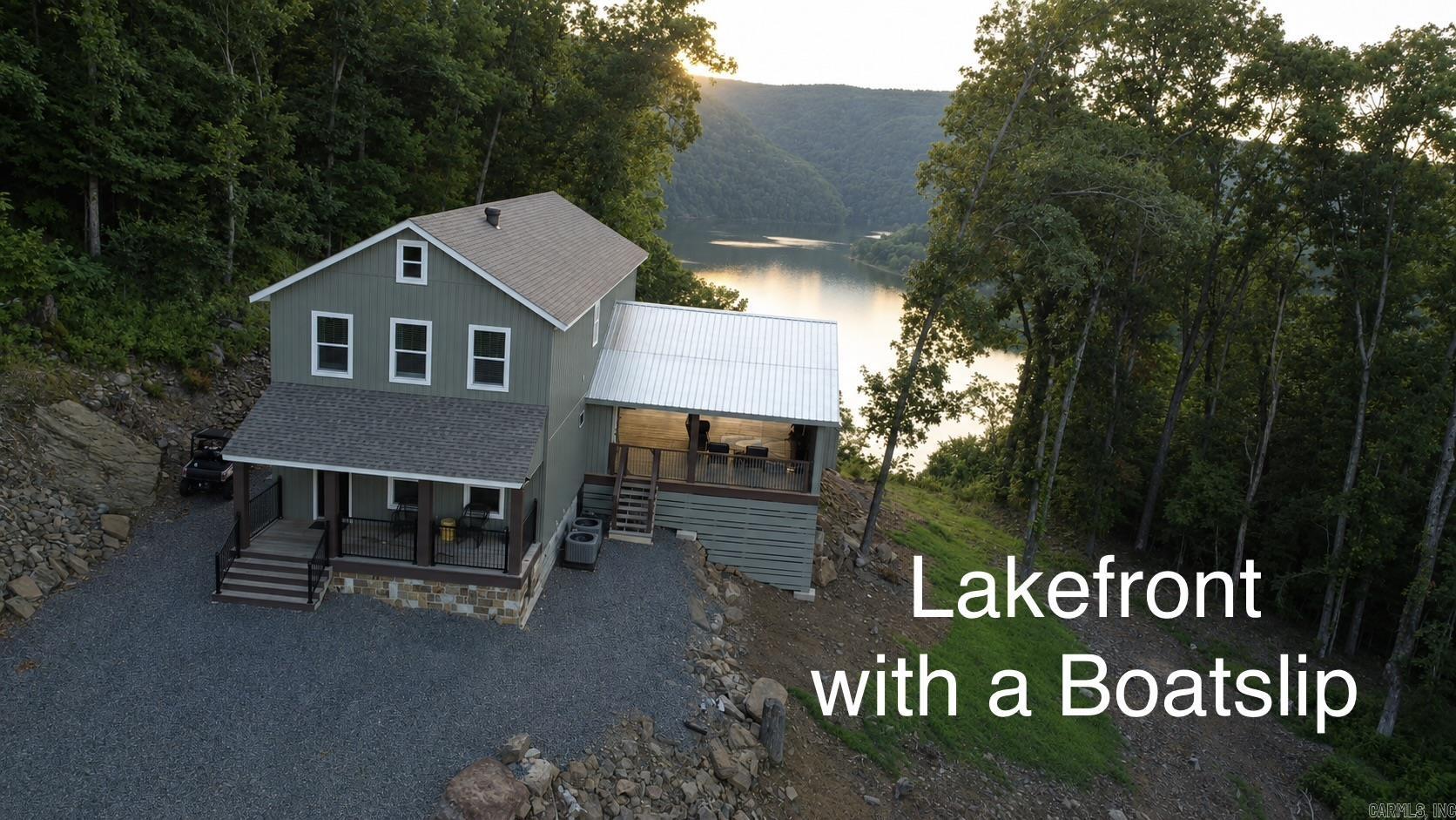 This Property checks a lot of boxes ..*BOAT SLIP *LAKEFRONT *PANORAMIC LAKE VIEWS *Newly Built Home *ACREAGE w/6.91 ACRES!!!! Great Location with Boat Slip in the Watersedge Community Dock (Slip #12) located in a protected cove off of Middle Fork on Greers Ferry Lake with easy access from the dock parking lot. Your guests will be Amazed as they pull up to park & immediately see the Gorgeous Views! It never gets old driving up to this home as you wind through the trees up the driveway & then the views open up as you pull up to the Lake House! Main bedroom on first floor w/ 3 other bedrooms upstairs off of the Gameroom (that also has lake views). Hand scraped 3/4" Solid hickory wood floors thoughout the home. Main level has an open kitchen/living room combo with more lake and mountain views plus walkout door onto the 24x32 covered porch w/gas fireplace (gas logs not present) where you can unwind from a day on the lake. (SEE LINKS FOR VIRTUAL TOUR AND VIDEO)