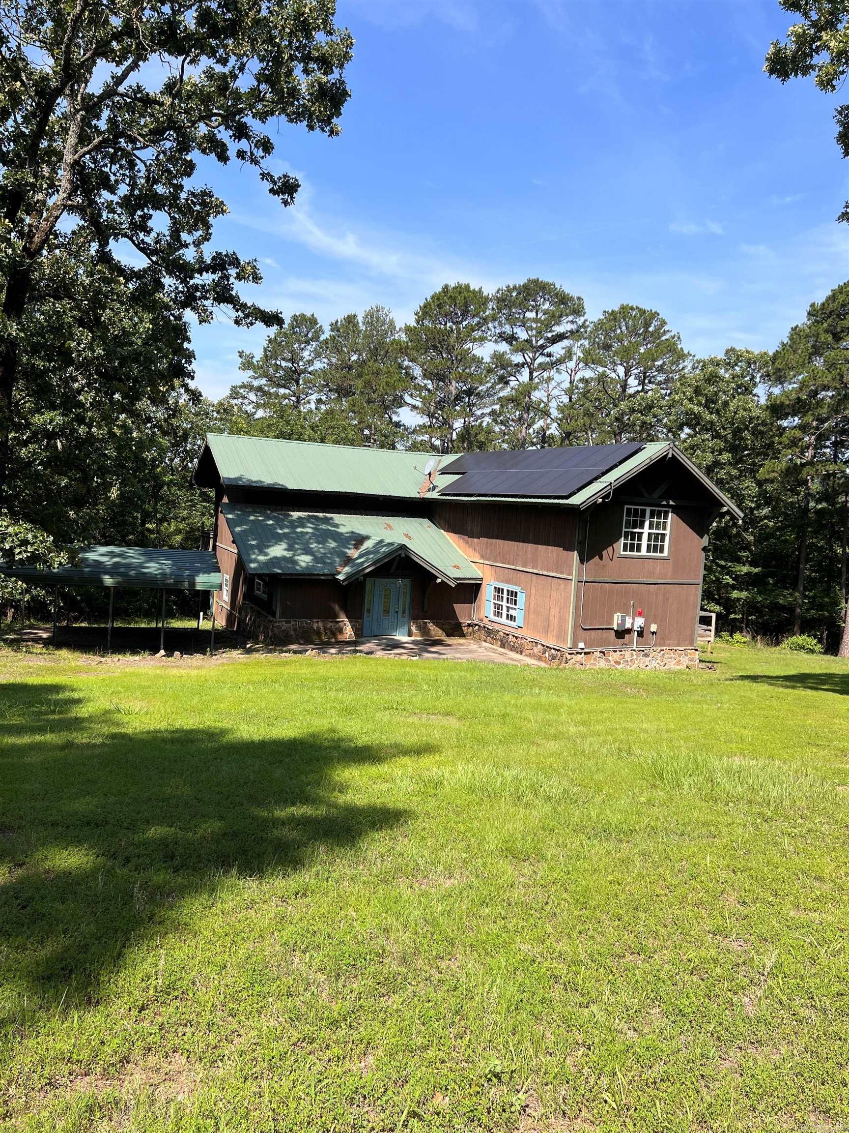 When you enter this home, you are welcomed by a striking multi-level layout that highlights the home’s unique design. Hand-crafted log accents throughout and concrete floors on the main. The main level features an open floor plan kitchen, dining area, and a cozy den, offering a functional layout for everyday living. The lower level includes 1 of the primary suites w/ a jetted tub leading into the ensuite, and an additional bedroom. * Take the wood staircase to the great room w/ a grand fireplace as the focal point. Floor-to-ceiling windows bring in abundant natural light & offer scenic lake views while overlooking a spacious deck. * Just a few steps above, the 2nd primary suite provides additional privacy w/ floor-to-ceiling windows with lake views and ensuite. * The property also presents an opportunity for short-term rental use, offering a quiet retreat with privacy, space, and natural surroundings. Located on a private road, the home provides a peaceful setting with convenient access to town amenities.