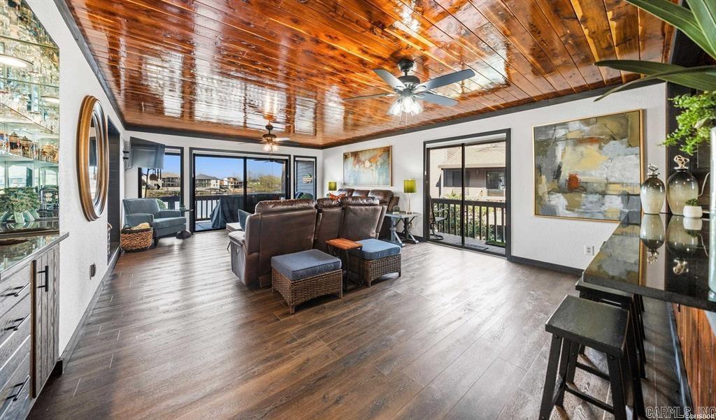 South Shore LAKE FRONT Beauty has been updated with a fun and cozy Lake Cabin vibe.  2BR/2BA waterfront condo with covered boat dock directly in front of your unit has granite counter tops, new floors throughout and new appliances. This fully furnished property offers an open floor plan, modern finishes, and custom built-in twin bunk beds for added sleeping capacity. Enjoy amazing, unobstructed waterfront views from the large private balcony—perfect for relaxing or entertaining. Located in a gated community for added privacy and security. Whether you're dreaming of quiet mornings by the water or lively summer gatherings, or adventures at Oaklawn this property is ready to become your personal lake haven.  Alternatively,  Short-term rentals allowed with no permit required, making this an excellent turnkey investment opportunity.  This wonderful community also offers swimming pools and tennis courts for your off lake pleasure.  You can decide how you want to use it and start ENJOYING Lake Hamilton and Hot Springs right away!