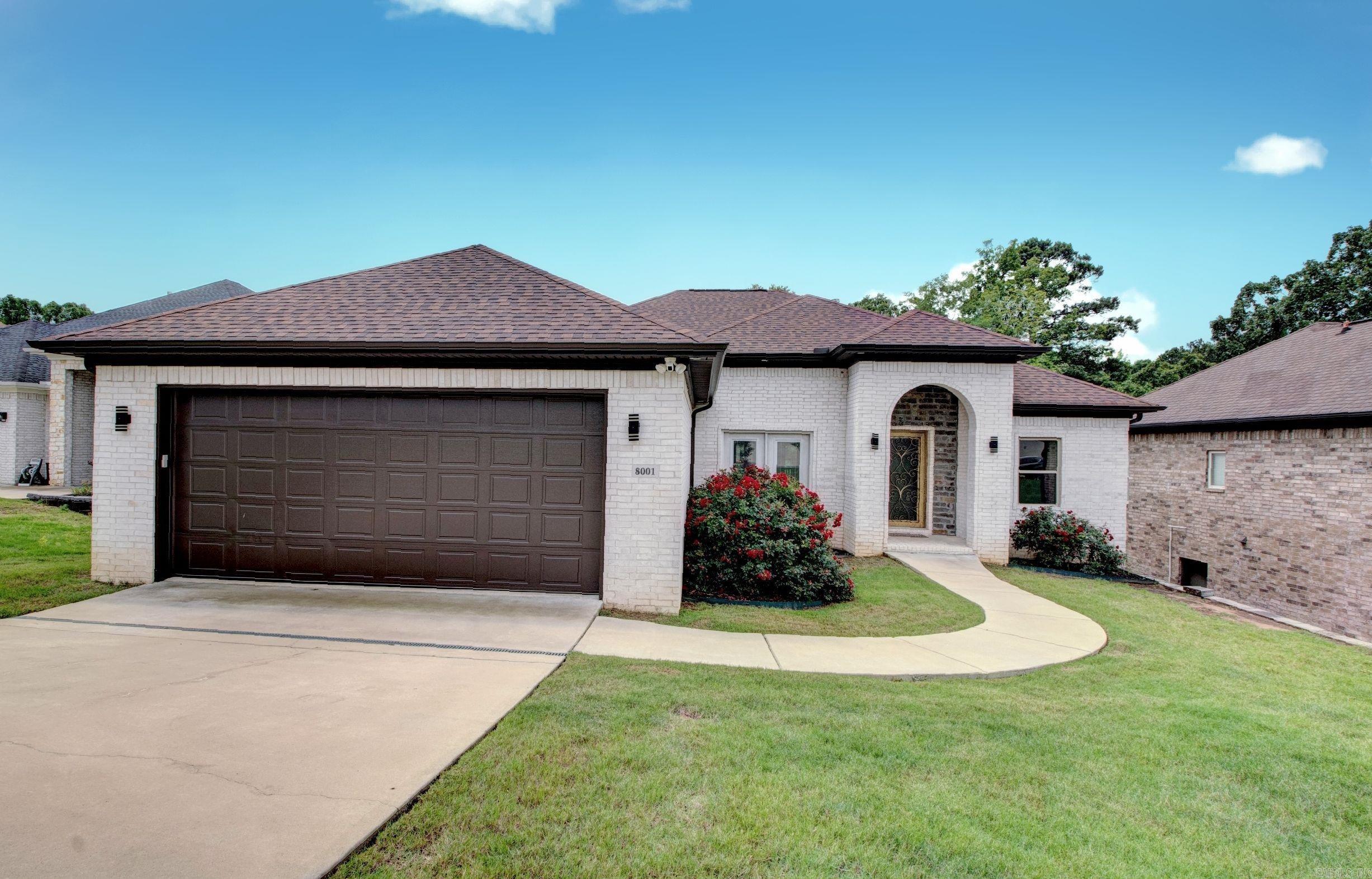 This Kanis Village builder's personal home features three bedrooms, two and a half baths, nearly 2,300 sq ft on one level, $18K of spray foam insulation, and tankless hot water.  Hardwood floors throughout except for wet area ceramic tile, and slab granite for all counter top surfaces.  The designated dining area, living area with mosaic tiled gas log fireplace and wall of built-in bookcases, and an eat-in kitchen with large island and four pendant lighting, five burner gas range with griddle, stainless appliances, walk-in pantry, and China cabinetry are open to each other.  The spacious primary suite features a rain head shower, jetted tub, double vanities, and walk-in closet with built-ins.  Both the primary and hall showers are ceiling to floor tiled and mosaic with heavy glass doors, all bedrooms have walk-in closets, the separate laundry room doubles as a half bath, and there are tall and trey ceilings, heavy crown molding, and contemporary lighting.   The property backs up to woods and pond for a peaceful setting, and that can be enjoyed from the large, covered back deck that overlooks it.  There is also a very large double door crawl space for ample outdoor storage.