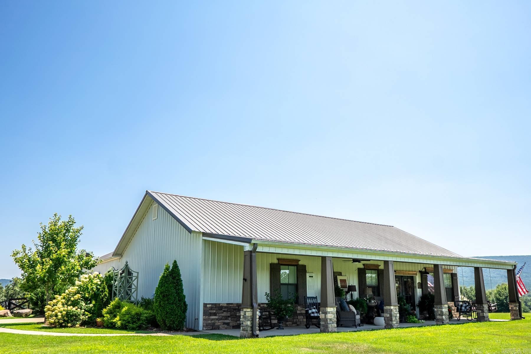 Beautifully built, luxurious custom home on 28.88 acres bordering the National Forest. This stunning 3-bed, 3-bath home offers approximately 2,568 sq ft of thoughtfully designed living space with vaulted ceilings, wood-burning fireplace, floor-to-ceiling window wall framing breathtaking mountain views, shiplap accents, and knotty pine and maple custom cabinetry throughout. Kitchen features granite countertops and gas stove. All three bedroom suites include their own bathroom with heated floors. Additional highlights include 3/4 knotty pine interior walls, Karndean flooring, adjustable built-ins, loft office, and storm shelter in the primary closet.  Outside, enjoy a 30x60 shop with lean-to, 16x12 greenhouse, storage garage, in-ground pool, rock patio with fire pit, and a 560 sq ft loft above the shop perfect for guests or multi-generational living. The acreage features mountain views, stocked pond, tower blinds, hunting stands, and direct National Forest boundary access. Refrigerator, washer and dryer, and loft furniture convey.