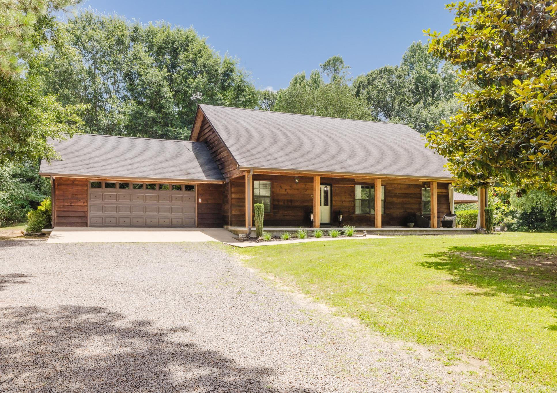 Welcome to this stunning custom-built home nestled on nearly 8 private acres, offering the perfect blend of luxury, comfort, and peaceful country living. This exceptional property features two spacious living areas, providing plenty of room for family gatherings. The beautiful fireplace serves as a warm and inviting focal point, adding charm and character to the main living space. Inside, you'll also find the added security and convenience of an indoor safe room, providing peace of mind during severe weather or serving as half bath.  Step outside and enjoy your own outdoor oasis the covered outdoor kitchen, perfect for entertaining year-round while taking in the peaceful surroundings. With nearly 8 acres of beautiful land, this property offers endless possibilities for outdoor recreation, gardening, or simply enjoying nature.  Act now to call this one-of-a-kind property home. *Agents See Remarks*
