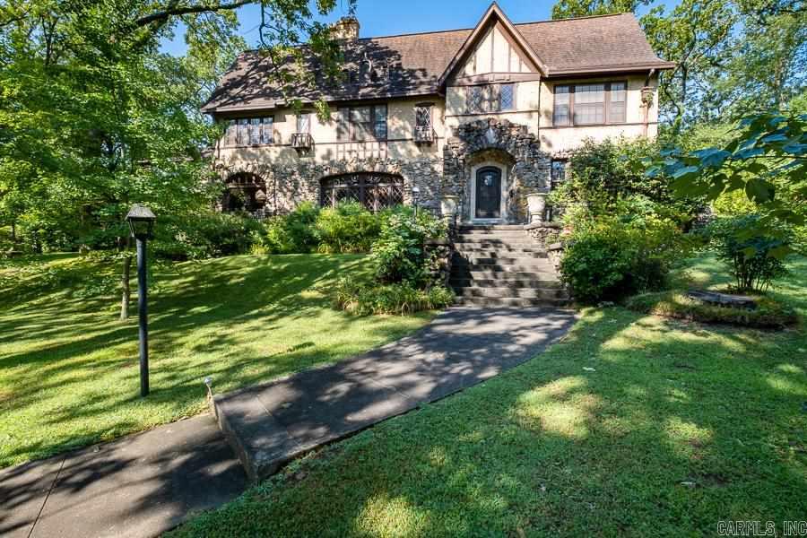 The Historic Storthz-Sherman House, designed by architect, H. Ray Burks, is one of the best examples of English Revival style in the city.  Lovingly preserved with most original fixtures throughout. Main level features impressive living and dining rooms great for entertaining, extensive diamond windows, fireplace, covered porch, updated kitchen with separate breakfast room.   Upstairs includes primary bedroom with large den, 3 bedrooms and guest bath.  Amazing 800sf guest house/library not included in sf.