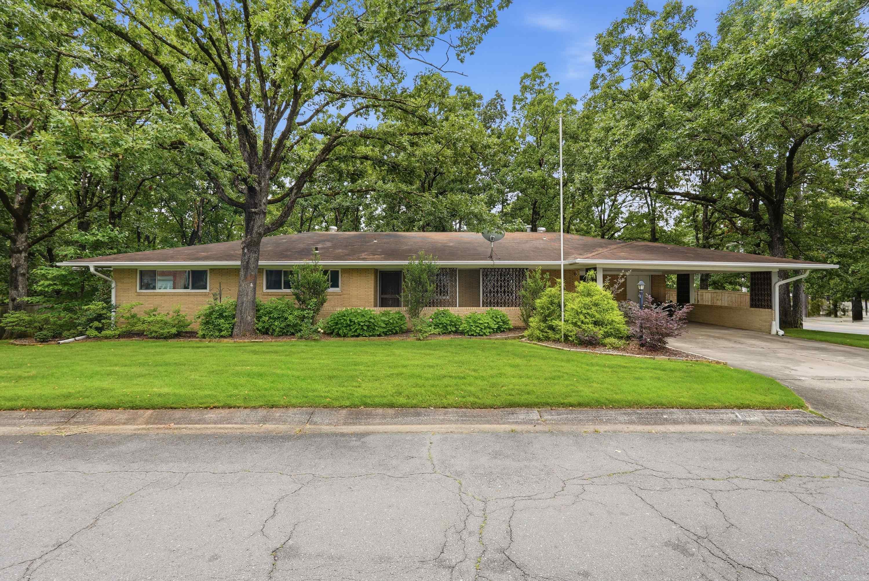 Welcome home to this charming 4-bedroom, 2.5-bath property nestled in the heart of Midtown! Situated on a rare double lot, this home offers plenty of space both inside and out. The floor plan features a designated living room plus a versatile bonus room just off the kitchen, perfect for a second living area, playroom, home office, or entertainment space. One of the bathrooms has been beautifully renovated, blending modern updates with timeless style. The two rear bedrooms share access to a bright sunroom, creating the perfect spot to relax and enjoy views of the backyard. Step outside to the spacious covered back porch overlooking extensive landscaping that provides a peaceful outdoor retreat. The attached carport includes three large storage rooms, offering exceptional space for tools, hobbies, and extra storage. Conveniently located near shopping, dining, parks, and all that Midtown has to offer, this home is full of character and opportunity.
