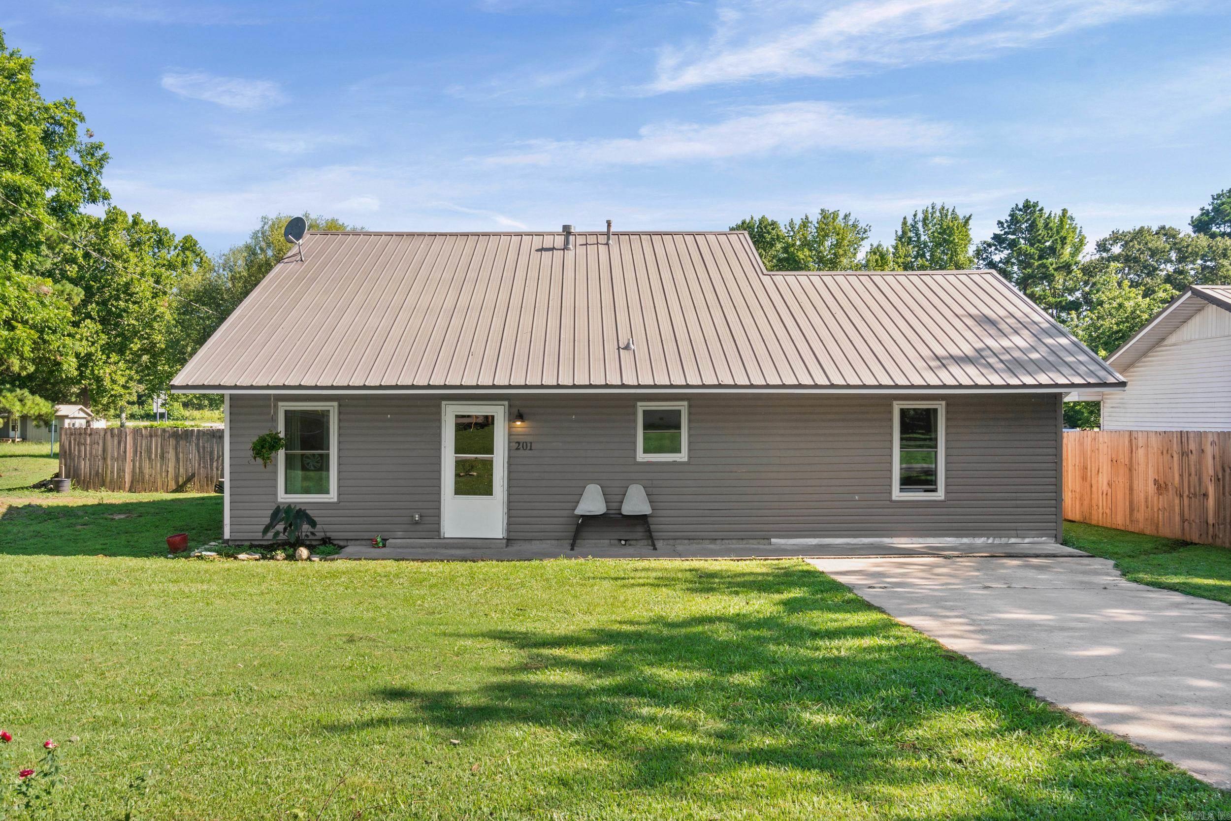 Picture yourself coming home to this beautifully renovated 3-bedroom, 2-bath home offering approximately 1,600 square feet of comfortable living space. The inviting layout is perfect for everyday living, while the updates throughout make this home truly move-in ready. The kitchen is large with tons of cabinet space.  Step outside and imagine your kiddos running and playing in the large, fully fenced backyard, your pets enjoying the space to roam, or friends and family gathering for cookouts on the covered back patio. Whether you’re enjoying a quiet morning coffee or spending evenings outdoors, this backyard is made to be enjoyed. For added peace of mind, the home features a metal roof replaced in 2018, heat/air units (2018), and a water heater replaced in 2023. With thoughtful updates, a spacious yard, and a welcoming feel, this is a place you’ll be proud to call home! Come see for yourself today!