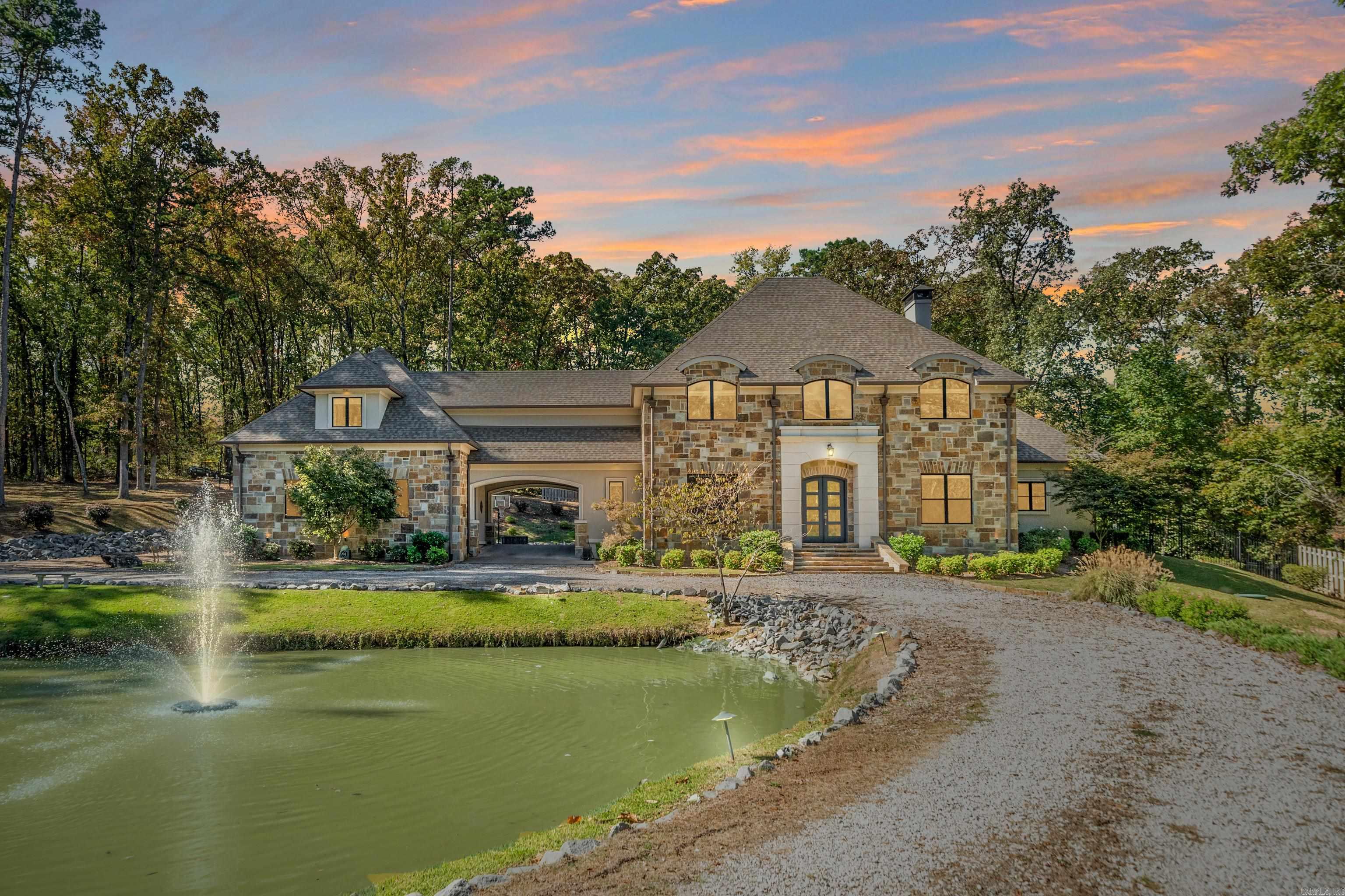 Refined Spaces, Relaxed Living!  Set within an exclusive gated cul-de-sac of just three homes, this estate-style property, on almost 3 acres, delivers privacy, sophistication and comfort in equal measure.  The main residence offers four bedrooms, three and a half baths, a dedicated office and plenty of flexible spaces including a media room and bonus room that easily adapt to your lifestyle.  Blending open space with thoughtful design and seamless flow, the kitchen brings ease to everyday living and energy to every gathering.  Step outside to the covered patio, where easy evenings by the fireplace meet the calming sound of the koi pond fountain.  A porte-cochere connects the main home to the guest quarters above the second garage.  With its own kitchenette, full bath, private bedroom and sitting area, it’s perfect for visitors, extended family or an independent workspace.  From the gated entry to the peaceful surroundings, this property balances privacy, elegance, and livability in a way that feels both refined and refreshingly relaxed.