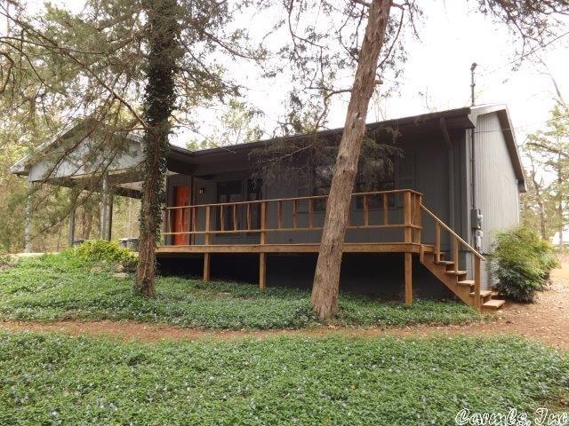 Comfortable Ozark Foothills home nestled in the woods.  2 nice sized bedrooms, 1 full bath, 6" walls, insulated doors and windows, central heat pump for heat and air, wonderful natural landscaped yard, established vegetable garden, 12x12 frame shop/storage building, 2014 metal roof, beautiful hardwood floors installed in 2012, covered front porch, very low property taxes, and close access to South Fork River fishing and swimming.