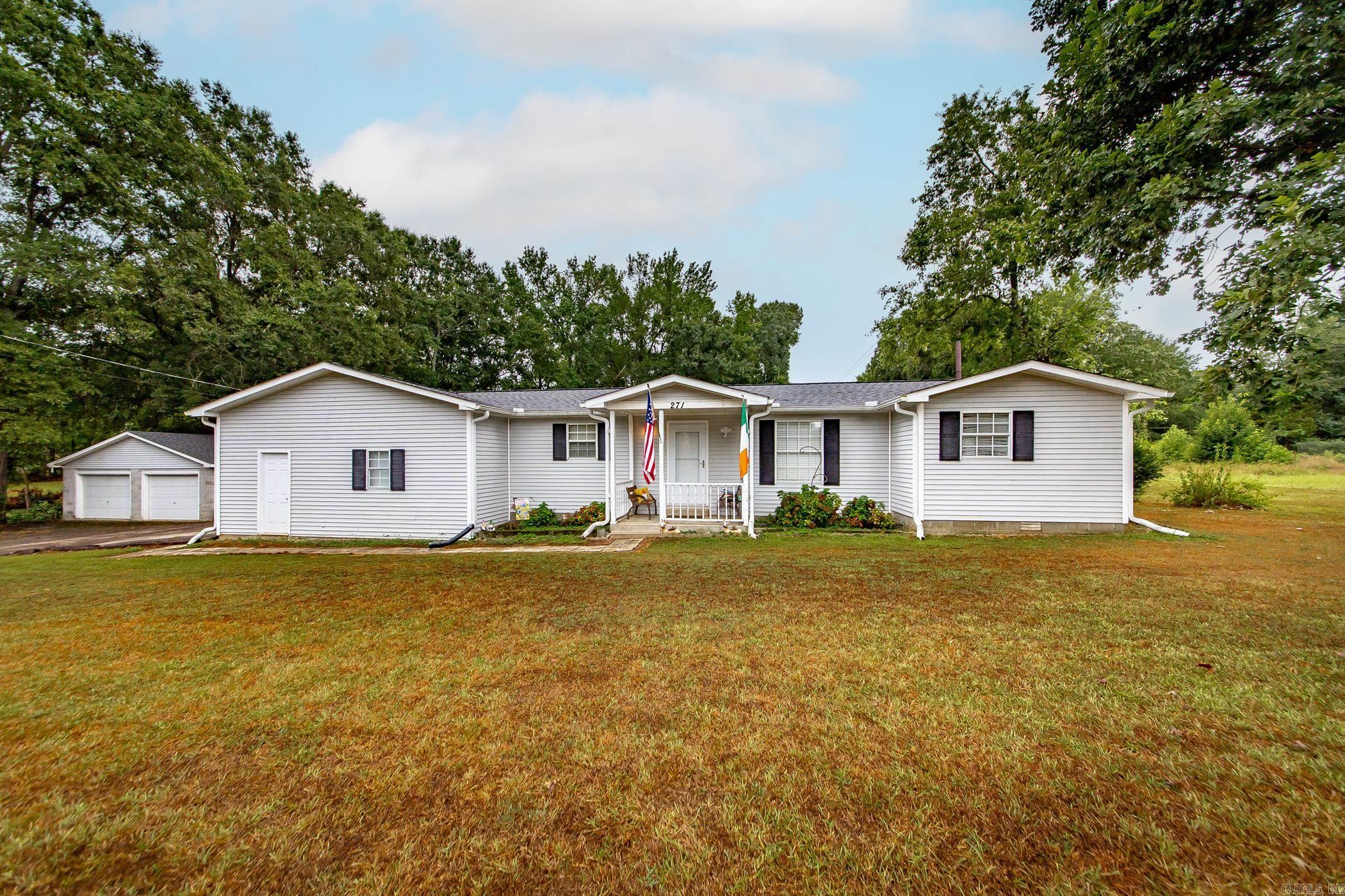 Plenty of space to enjoy the outdoors on this 2.5 acre property with a pond and a shed with electricity!  4 bedroom, 2 bath home with 2 car attached garage and 2 car detached garage, spacious kitchen with island, nice sized living room and den, formal dining room with fireplace, and this home has a Generac whole house generator approx. 3 years old.  New roof on home, detached garage, and shed (approx. 2 years old).   Some newer flooring was added in 3 bedrooms, living room, and hallway.  2 refrigerators, washer, dryer, and freezer will convey to Buyer.  Taxes stated are after homestead credit.  Agents, see remarks.