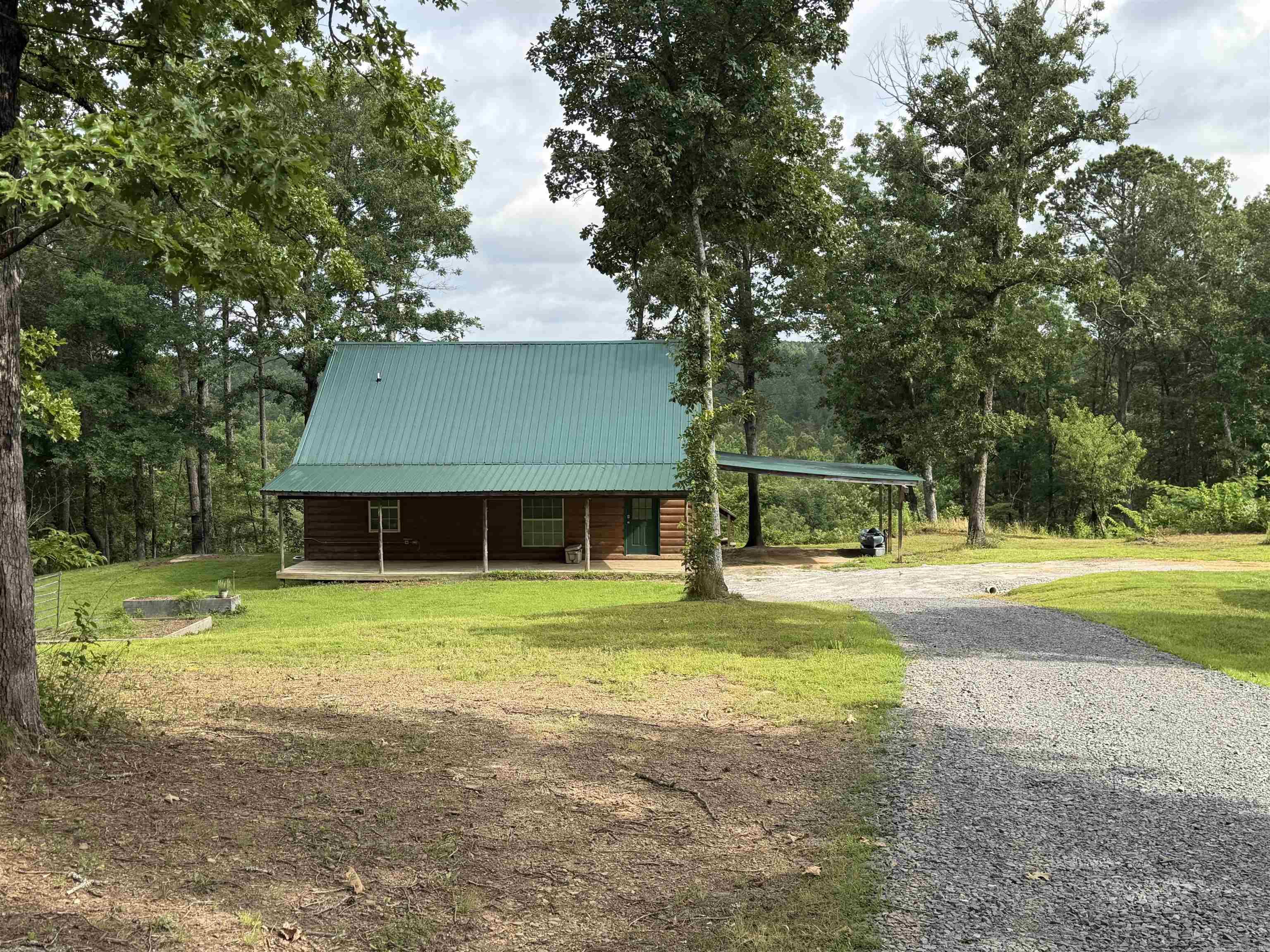 OZARK MOUNTAIN RETREAT  Escape to the beauty of the Ozarks at 375 Batesville Mountain Road in Damascus, AR. Situated on 10.83 private acres approximately ¼ mile off the highway, this unique property offers privacy, scenic views, and abundant wildlife.  The 1,208 sq. ft. home features 3 bedrooms, 1 bath, cathedral ceilings, and a loft bedroom overlooking the main living area. A full-width front porch provides breathtaking north-facing views of the Ozark Mountains, making it the perfect place to relax and enjoy the surrounding landscape.  Whether you're sipping your morning coffee, entertaining guests, or simply unwinding at sunset, the views alone make this property  Behind the home, a wooded hillside filled with mature hardwoods leads to Batesville Creek along the property's northern border. The land attracts deer, turkey, squirrels, and rabbits, creating an ideal setting for nature lovers and hunters alike. A well-built deer stand on the lower plateau is ready for next season.  Whether you're looking for a peaceful full-time residence, a hunting property, or a weekend retreat from city life, this property offers the perfect combination of comfort, recreation, and natural beauty.