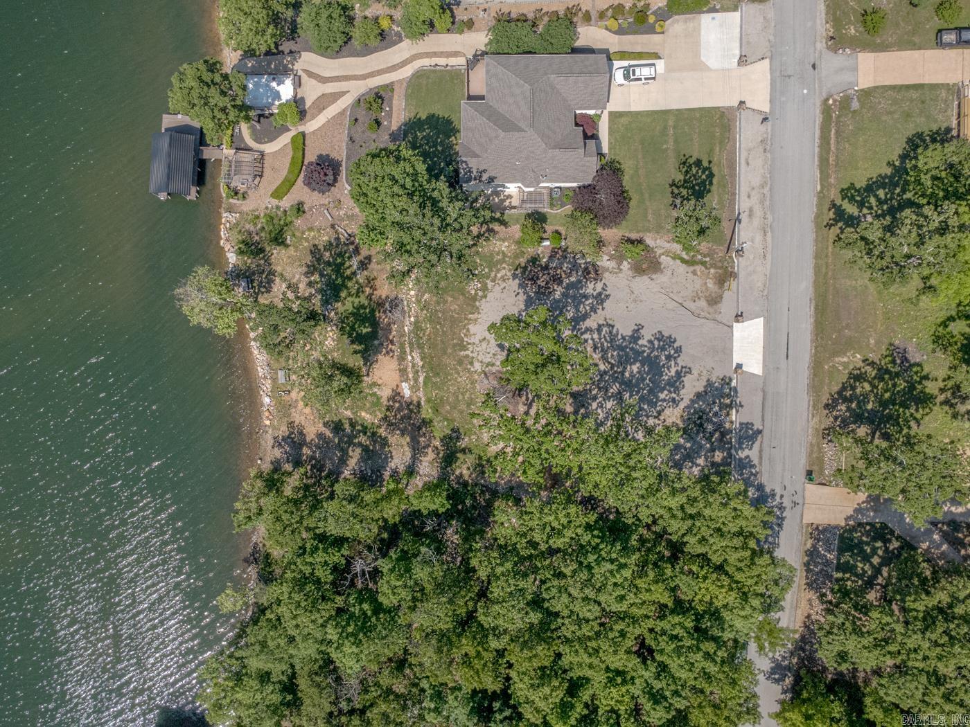 Welcome to Market 1503 Emerald Cove in Horseshoe Bend, AR. Situated on a 0.50 +/- acre waterfront lot in the Emerald Cove Addition offering 111 +/- ft of shoreline frontage on 640 +/- acre Crown Lake is an opportunity to secure your own piece of lake life. Sprinkled w/ mature shade trees and already cleared for your future build, the groundwork has been laid for your custom home, or investment property. Seller improvements include professional land clearing designed to maximize views and natural beauty, rock shoreline reinforcement for a natural waterfront appearance, compacted and settled site preparation for a future home and patio/garage area, plus a concrete and steel approach and decorative estate-style frontage wall w/ water and electric available to the property. Enjoy direct access to boating, fishing, skiing, kayaking, and your favorite water activities right from your own backyard. Located within a subdivision featuring marina access, golf course, clubhouse, playground, fitness/bike trail, and nearby airport access. You'll love all the amenities that Horseshoe Bend has to offer. Call today to schedule your tour and make an investment in tomorrow.