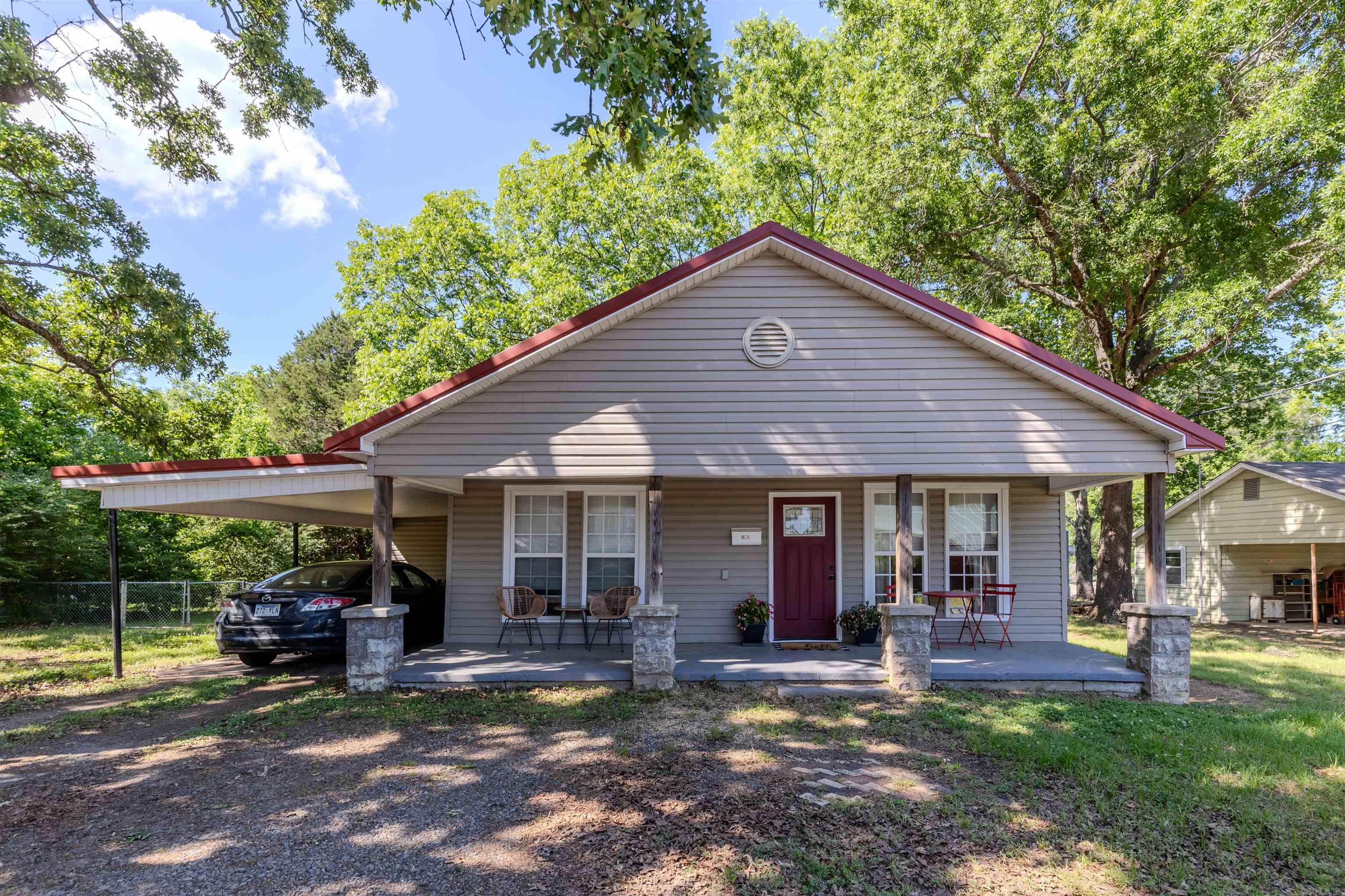 Beautifully renovated from top to bottom, this move-in ready home blends modern updates with timeless small-town charm! Relax on the welcoming 8’x28’ front porch or enjoy the spacious, fully fenced backyard complete with a large storage building for added convenience. Inside, the open-concept layout features a bright living, dining, and kitchen area highlighted by brand-new granite countertops, stainless steel appliances, updated lighting, and crown molding. Also, the refrigerator will convey! Major upgrades include all-new spray foam insulation, sheetrock, flooring, electrical, plumbing, ductwork, and fresh paint throughout. The home also offers spacious bedrooms, a walk-in closet, and a beautifully updated hall bath with a walk-in shower and granite vanity. A dedicated laundry room with built-in cabinetry and washer/dryer hookups adds everyday functionality. With low-maintenance siding, a metal roof, and newer windows, this home is designed for easy living and lasting value. Conveniently located near hospitals, shopping, and interstate access — this one is truly turnkey and ready to welcome you home!