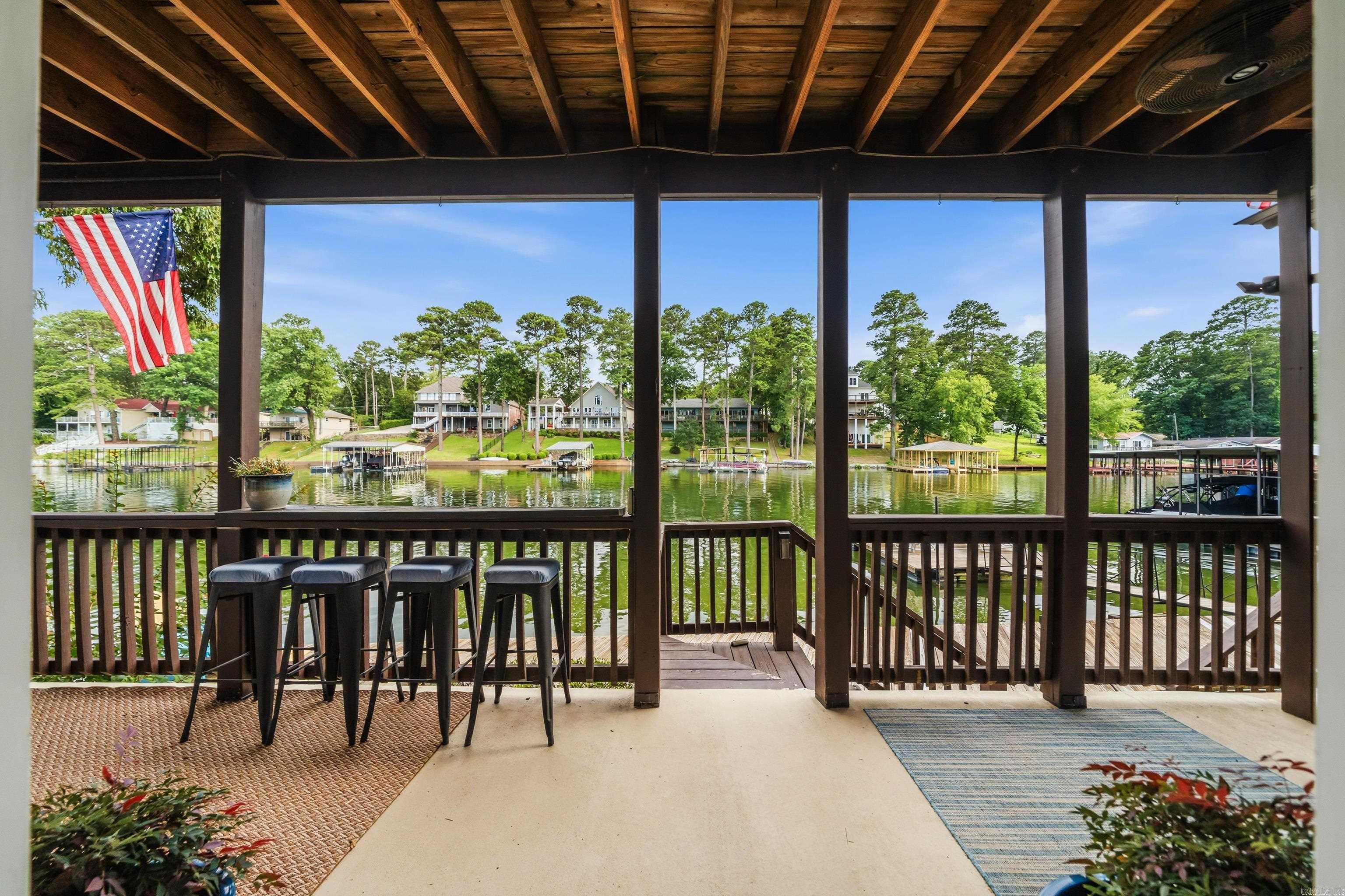 Wake up to the water every single day. This completely remodeled lakefront condo on beautiful Lake Hamilton delivers the full lake life experience. From the moment you step inside, the quality of the updates is evident — brand new kitchen with modern appliances, fully updated bathroom with fresh fixtures, and new flooring throughout.  The lower level unit places you just steps from the water, where a swim dock and direct lake access are ready for summer. Turnkey and move-in ready, this condo is the perfect primary retreat or weekend escape Opportunities like this on Lake Hamilton don't last — schedule your showing today.