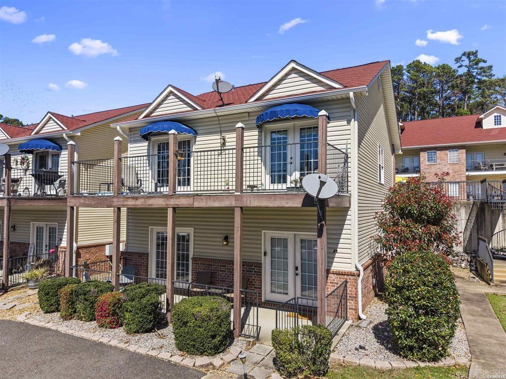 Enjoy easy lake living in this 2-bedroom, 2-bath single-story walk-out level condo located on desirable Peters Point on Lake Hamilton. This convenient ground-level unit offers beautiful views of the pool and easy access with no stairs to climb. Relax on your private patio and enjoy the lively lake atmosphere just steps away.  This condo is also a successful short-term rental and is being sold completely furnished, making it a fantastic turnkey investment opportunity or personal getaway. Furnishings include washer, dryer, and refrigerator, so it's ready for immediate use or rental.  Located near all the action Lake Hamilton has to offer, you’ll be just minutes from the fireworks shows, boat-accessible restaurants, the mall, and popular shopping destinations. Whether you're looking for a weekend retreat, income-producing property, or full-time residence, this condo offers the perfect blend of comfort, convenience, and lake lifestyle.