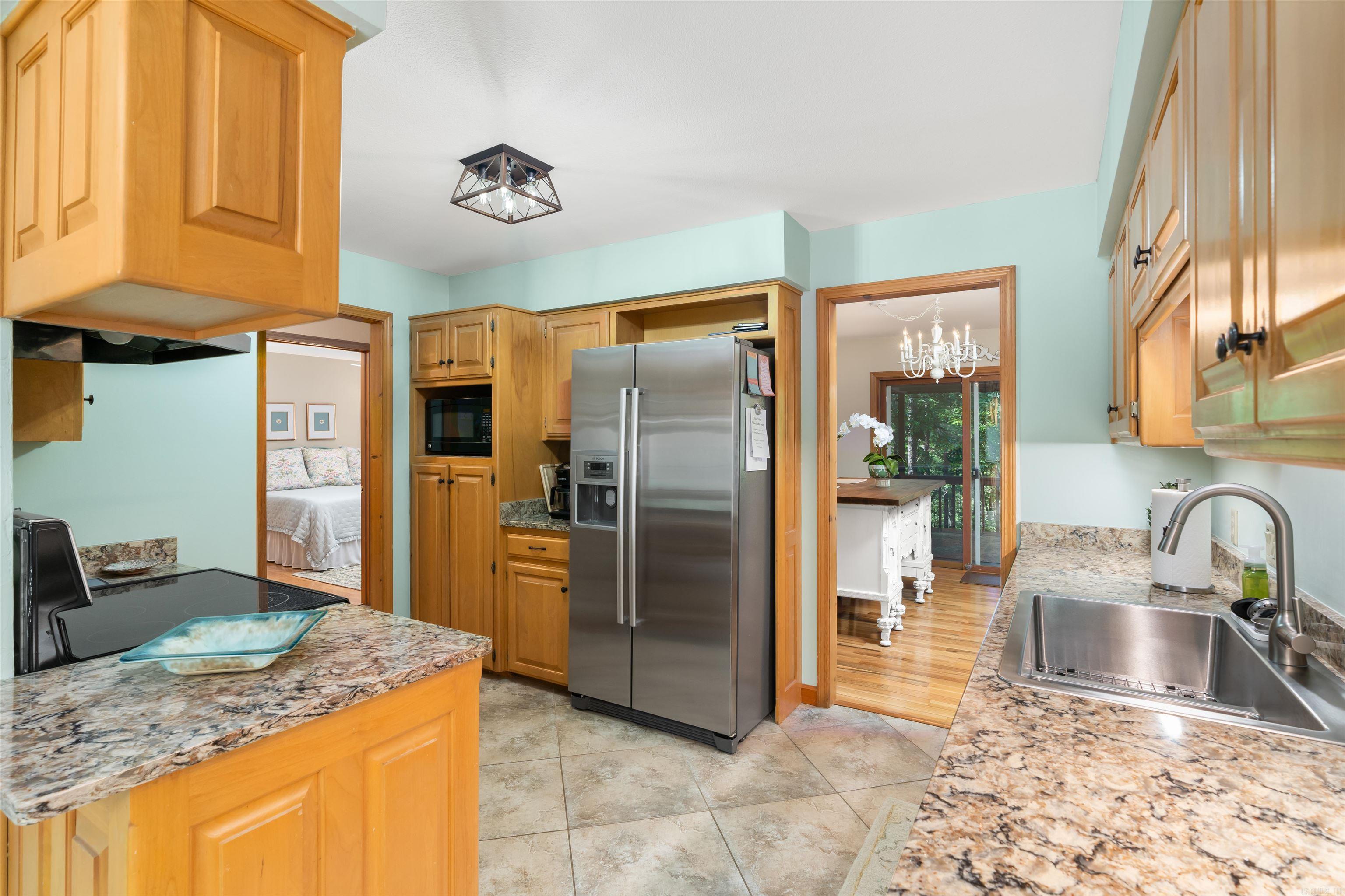 This beauty has 2 decks for all your entertaining needs! With a NEW roof in 2024, gas logs installed in 2025, new PEX lines in 2024, and a new stainless steel sink and faucet...this house is move in ready! The crawlspace is insulated and comes with the dehumidifier. Level driveway and low maintenance yard! Hardwoods floors in most of the house and newer carpet in 2 bedrooms. Gorgeous Roman shades in all the bedrooms and the dining room make this home inviting and cozy. Call today for your showing! AGENTS SEE REMARKS