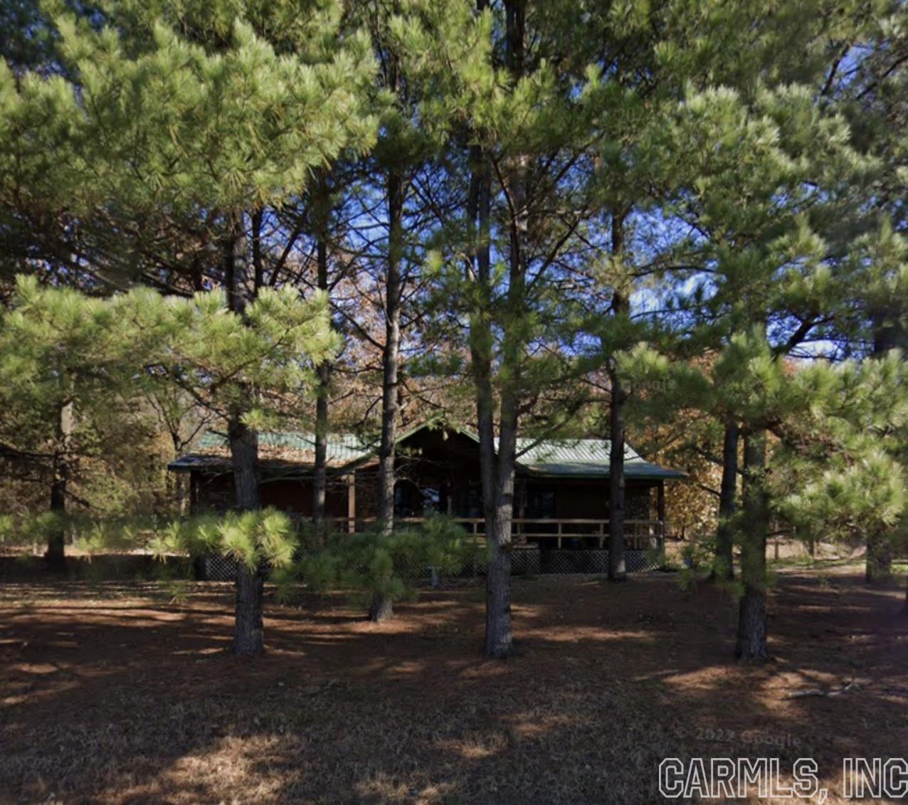 This home is ready for its new owner. This rustic charming wood and rock house has a large inviting porch that is the length of the house, a spacious open floor plan with vaulted ceilings. The large master bedroom with a nice walk in closet and double vanities in the oversized master bathroom. The kitchen has lots of cabinet space and the oversized laundry room has plenty of storage space.