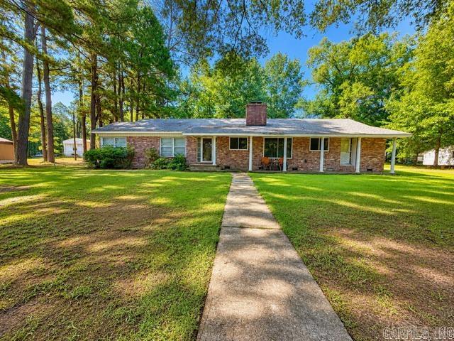 Welcome to 906 E. Walnut in Gurdon—a beautifully maintained 3-bedroom, 2-bath home situated on over half an acre, offering the perfect blend of comfort, space, and timeless charm. Inside, there is the living room with rich wood-look flooring, built-in shelving, and a cozy brick fireplace with a warm wood accent wall, creating the perfect gathering space. The inviting sunroom provides a bright, relaxing retreat with views of the backyard and plenty of natural light. The kitchen offers generous cabinet and counter space, making meal prep and entertaining easy. The oversized primary suite provides plenty of room to unwind, while the additional bedrooms offer flexibility for family, guests, or a home office. The updated bathroom features a luxurious clawfoot soaking tub, walk-in tiled shower, and stylish finishes. A large walk-in closet provides exceptional storage. Outside, enjoy the peaceful setting from the expansive patio overlooking the tree-lined backyard. The large lot offers room to garden, play, or simply relax in a quiet setting. Conveniently located near schools, shopping, and local amenities, this move-in ready home combines space, character, and functionality. Don't miss