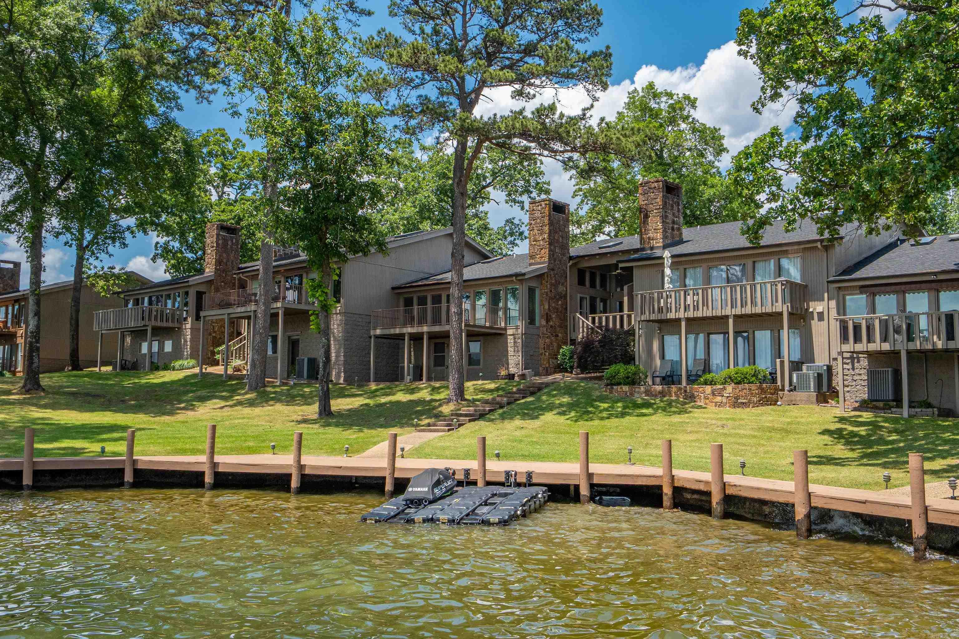 Wonderful location and view !! Step into this 3 bedroom and 3.5 bath with lots of closet space, wet bar with wine fridge and icemaker, stone fireplace, large deck and an open floor plan. Side deck with steps down to lake. Covered boat slip, pool, clubhouseand gated. This complex is very lovely and you will enjoy the grounds, pool and clubhouse. Walk along the boardwalk at the watersedge and enjoy the nice shady lawn areas.