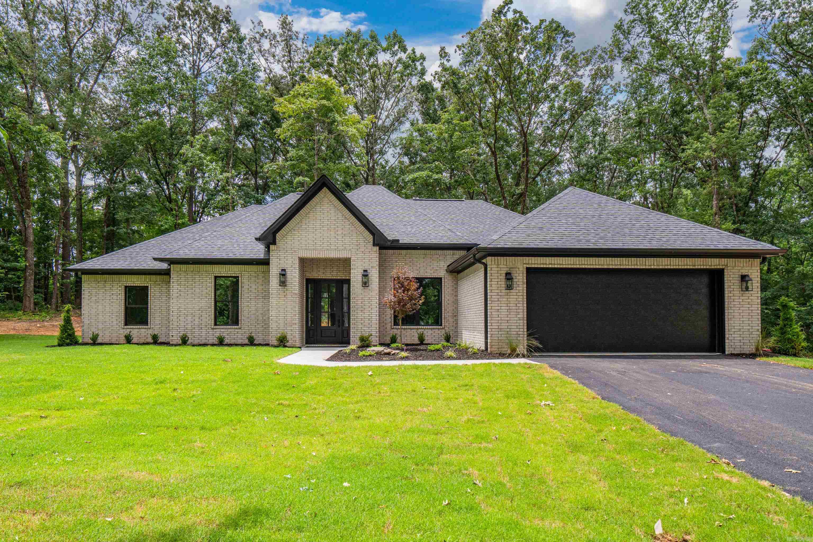 Prepare to be impressed by this stunning 4 bedroom 2 bath, custom-built brick home offering premium living with top-tier curb appeal. Located in the highly desired Lakeside School District. From the moment you step inside, you are greeted by a light-filled main living area featuring soaring 12-foot ceilings and a sleek electric fireplace that serves as a beautiful focal point. The seamless layout flows beautifully on gorgeous luxury vinyl plank flooring that runs throughout the  home. The chef’s kitchen is a standout feature, complete with quartz countertops, an oversized gas cooktop, and a massive walk-in pantry that offers unparalleled storage. The master suite serves as your private oasis, showcasing elegant tray ceilings. In the master bath, you will find a spa-like retreat featuring a modern free-standing soaking tub, a custom tile shower, and premium finishes. Step outside to find a beautifully manicured, landscaped yard ready for summer enjoyment. Whether you are hosting weekend BBQs or enjoying a quiet morning coffee, the spacious covered back patio provides the perfect outdoor escape. This home is completely turn-key and waiting for you—schedule your private tour today!