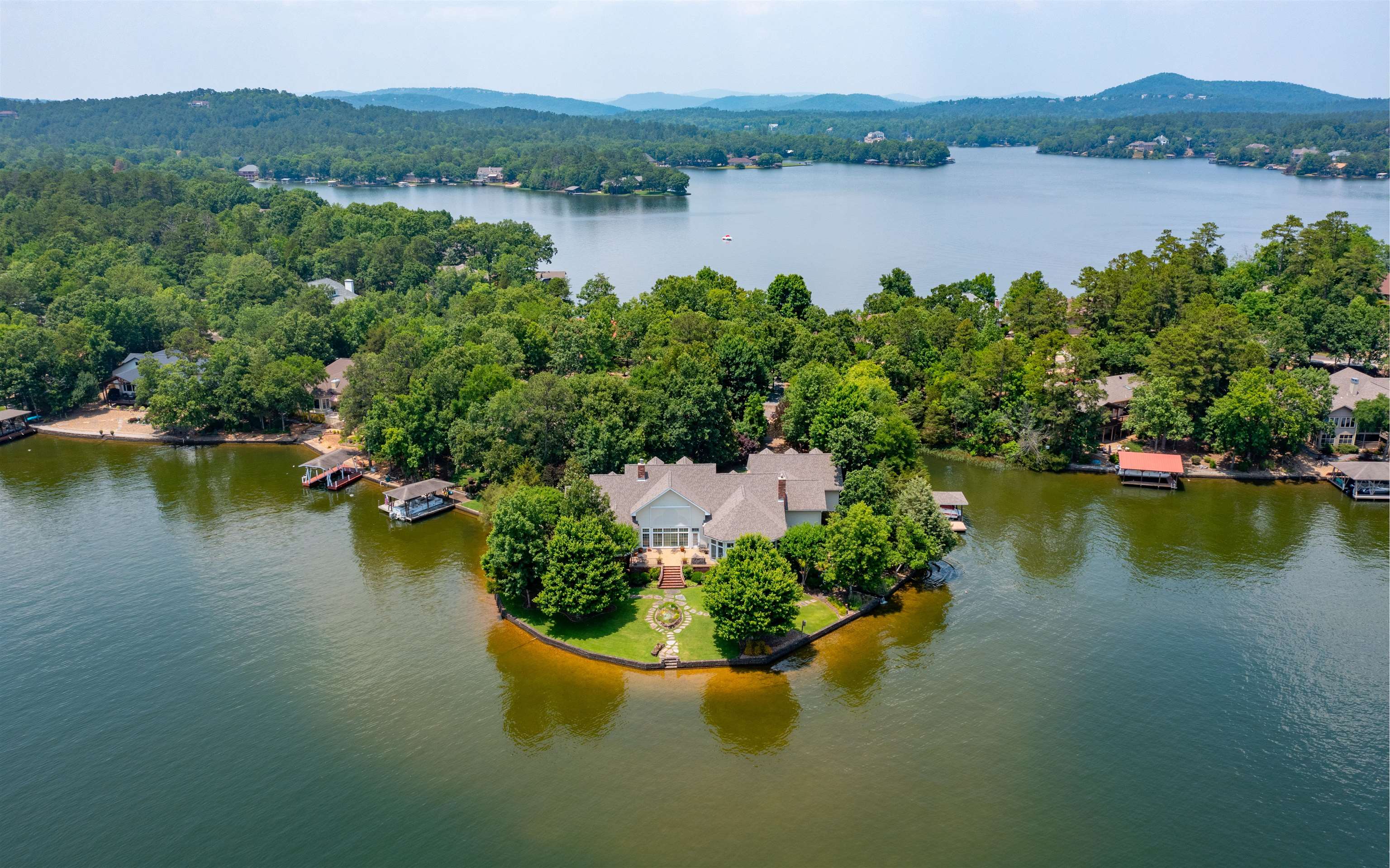 Amazing Custom Gerald Ellison built home on a Private, nearly 3/4 Acre Point on Lake Balboa! Quality everywhere, from the Hardwood Flooring with Inlays, to the Rounded Corners, Coved Ceilings and Walls of Windows overlooking the Lake! In addition to the Owner's Suite with Sitting Area, 5 Piece Ensuite and MASSIVE Walk-in Closet, is what could be considered a 2nd Owner's Suite on the opposite end of the house! The Gourmet Island Kitchen offers Granite/Corian Counters, Concealed Cabinetry for the Commercial size Refrigerator and Dishwasher, and Pass-through to the Sitting Room that enjoys a Brick Alcove with Wood Burning Stove for those cold Winter nights! Zoned Heating, Whole Home Speaker System, Security System, Solid 6 Panel Doors, Large Laundry Room with Wash Basin, Big Pantry. The Glass/Screened Arkansas Room opens to the Huge Patio for the ultimate BBQ! Mature Landscaping for Privacy, Waterfall feature with Creek to the Lake, Covered Boat Dock with Lift, Huge Raised Bed for Garden, and Full Irrigation System! Roof and HVAC System are only 3 years old!