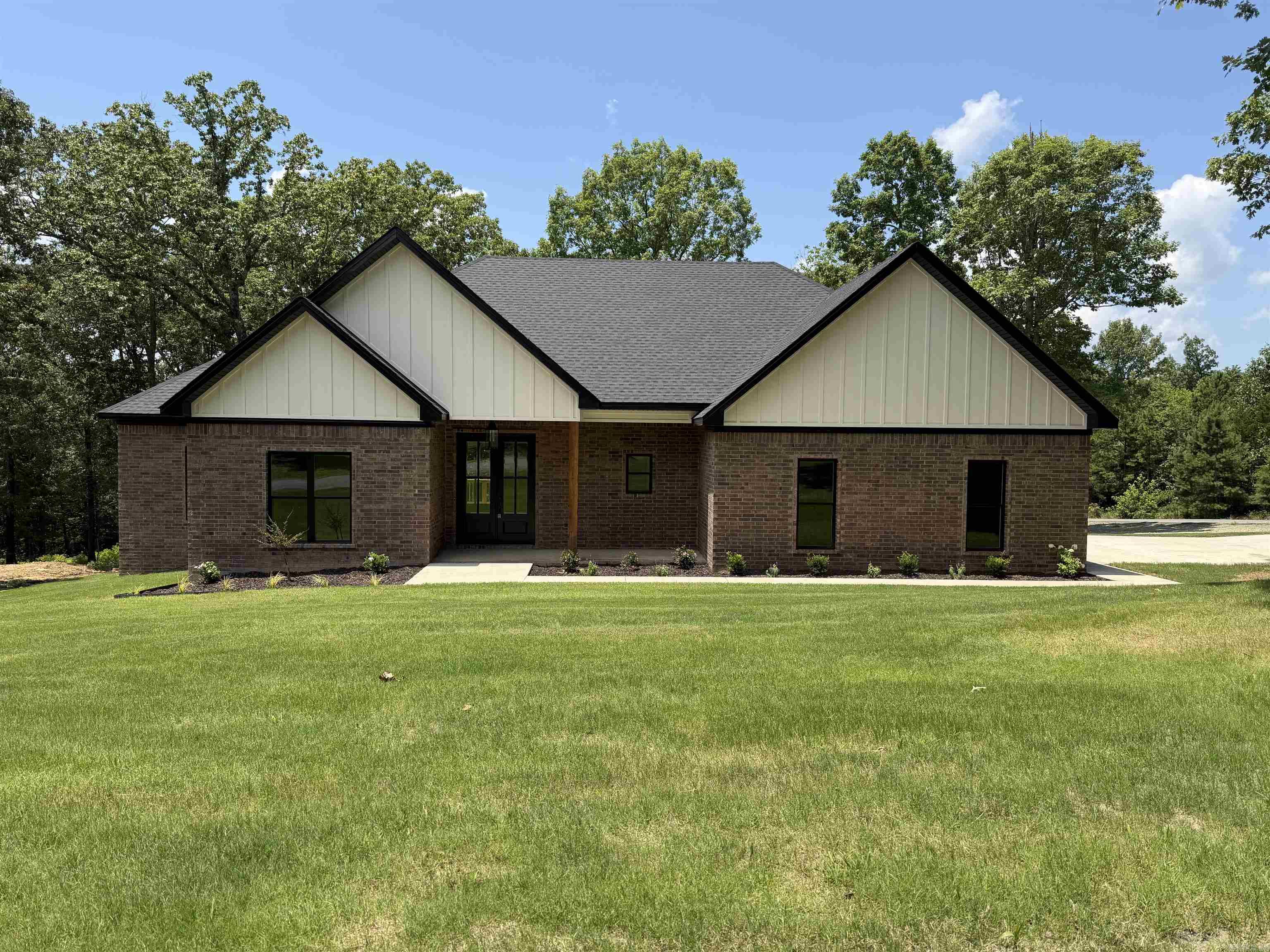 Brand New Construction Near the Lake!   Welcome to your dream home just minutes from Hill Creek Marina! This stunning 4 bedroom, 2.5 bath new build offers the perfect blend of modern style, comfort, and space.  Step inside through the beautiful double front doors and into an inviting open-concept floor plan where the kitchen, living, and dining areas flow seamlessly—perfect for entertaining or everyday living. The home will features vinyl plank flooring throughout, giving it a clean, modern look with easy maintenance.  The spacious primary suite is truly a retreat, offering a large walk-in closet, soaking bathtub, walk-in shower, and his & her vanities—designed for both comfort and functionality.  The kitchen is a standout with a walk-in pantry, providing plenty of storage and convenience for everyday living.  Situated on a beautiful, slightly sloped corner lot, this home offers both charm and curb appeal. Step out onto the back porch overlooking the peaceful property, the perfect place to relax and enjoy the surroundings.  A design board will be attached, giving you a preview of the carefully selected flooring, tile, and color palette that will bring this home together with
