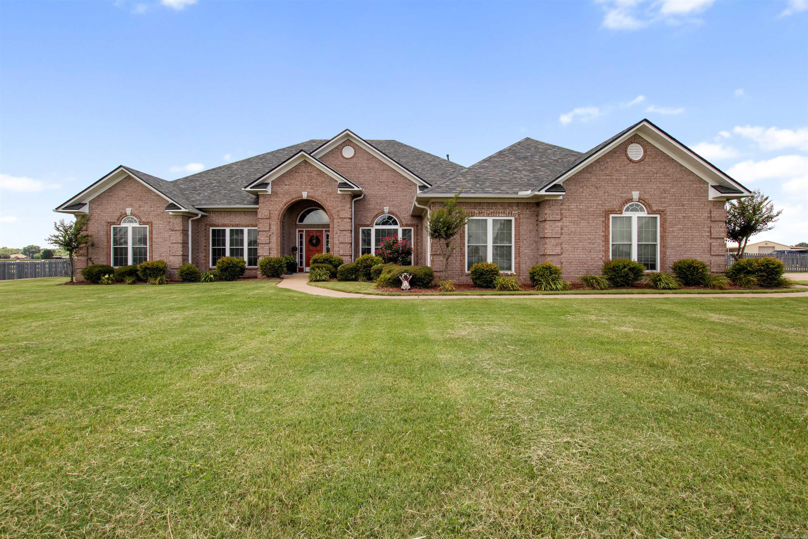 Welcome to your own private slice of Arkansas paradise! Nestled on 10 beautifully maintained acres in Scott, this stunning 2,940-square-foot home perfectly blends country charm with timeless elegance.  Step inside to discover a spacious floor plan featuring 3 bedrooms, 2 bathrooms, a private office, a formal dining room, and a sunny eat-in kitchen designed for everyday living. The functional kitchen offers an abundance of cabinetry, making meal prep and entertaining a breeze. The inviting living room showcases gorgeous built-in shelving, while the oversized primary suite provides the perfect retreat with a spacious bedroom and luxurious ensuite bath.  Outside is where this property truly shines. Relax on the covered back porch and enjoy peaceful country views, or take advantage of the incredible 30x40 heated and cooled shop. Horse enthusiasts will love the four horse stalls with a hay loft, two horse runs, and beautifully maintained white vinyl fencing surrounding the two separate 5-acre pastures—ready for your horses or other livestock.  Additional features include a 3-car garage, gorgeous curb appeal, and a setting that offers both privacy and convenience. Come See!