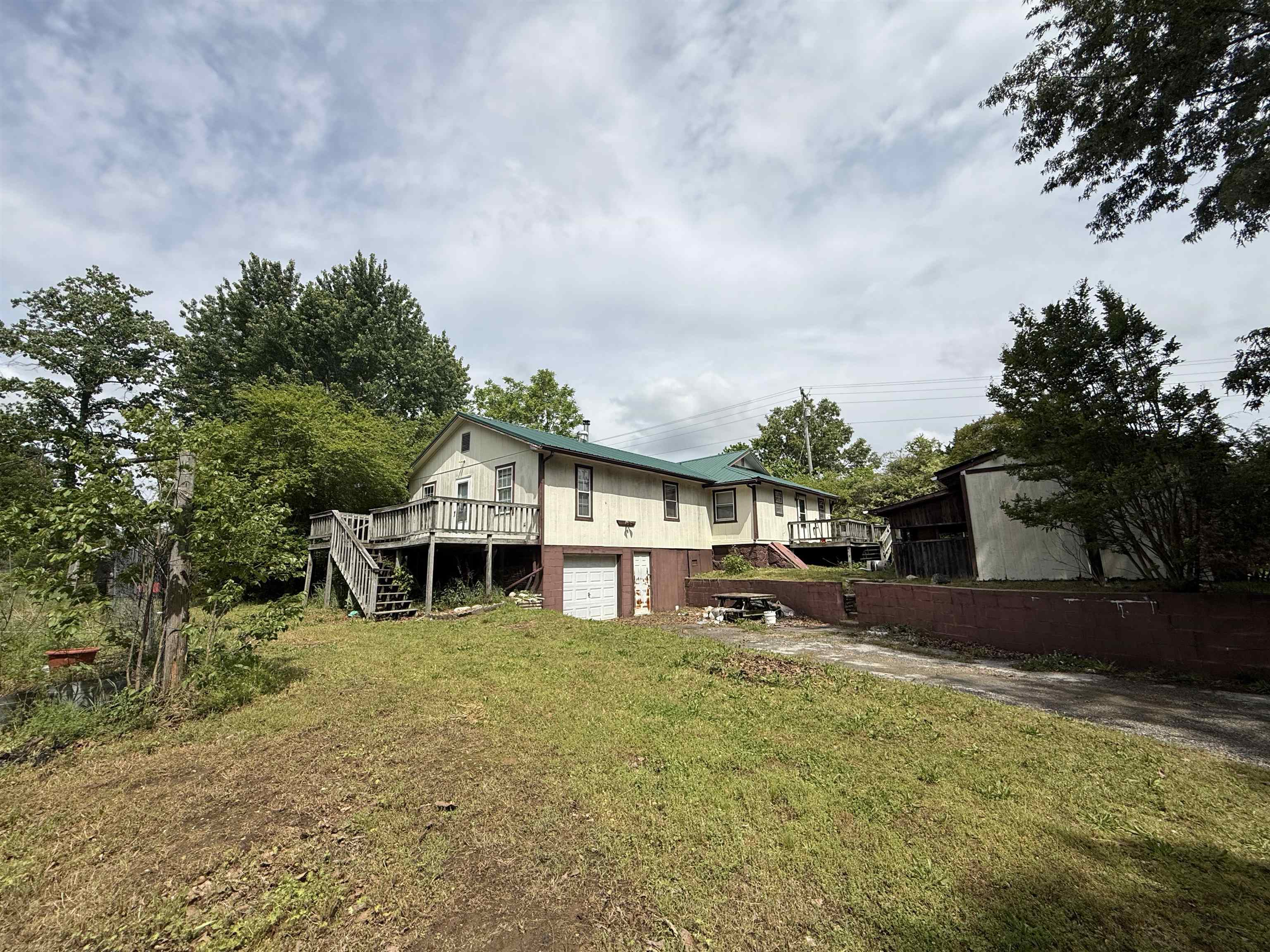 This 3-bedroom, 2-bathroom home is situated on 20.43 acres just outside Oxford, Arkansas, offering small-town living and plenty of space to enjoy. The land is fairly level and features a balanced mix of open ground and big timber, making it ideal for livestock, recreation, or simply enjoying the outdoors. A pond, stocked with fish, add to the property’s appeal, along with a functional cattle corral, run-in shed, and a small hay barn. TThe home is an older-style residence with solid features, including a metal roof that is only 5 years old and central heat and air with a heat pump and gas backup for added efficiency. With 3 bedrooms and 2 bathrooms, the layout offers comfortable living space and is ready for your personal touch. This property is vacant and move-in ready, making it a great option for a full-time residence, hobby farm, or investment opportunity, all at the low price of $127,500.