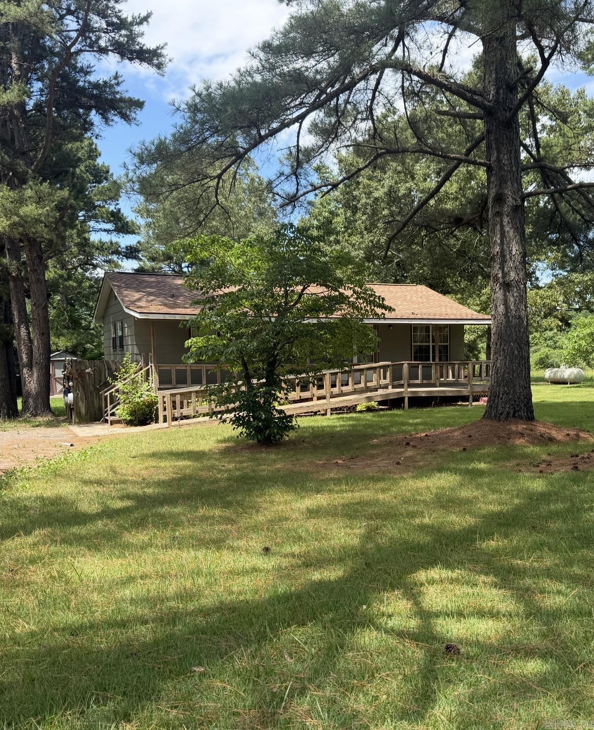 Property Highlights  The Main Home: Escape to the peace and quiet of the Arkansas Woods! 35 minutes to Batesville, AR. You can find yourself this charming home with 3 bedrooms, 1 bath, new stove and new dishwasher, with a covered porch that runs the length of the house. Theres a great sitting porch on the back of the home as well.  RV Setup: Two established RV sites equipped with 30/50-amp electricity and water. There is a separate meter that these two RV locations share, a sperate mailbox with a different address, and they also share a separate septic tank than the home. One of the RV sites has a large wood deck to park beside and walk out on it.  There are 4 outbuildings on the property. One small utility building (8x10) has water and electric. The second utility building (12x24) also has electric, a window, side door, and roll up door, along with a covered carport attached. The third utility building (12x20), and the fourth (8x12) has a wire pen attached, that could be used for dogs, goats, or chickens.  It has endless possibilities on this great little piece of property!