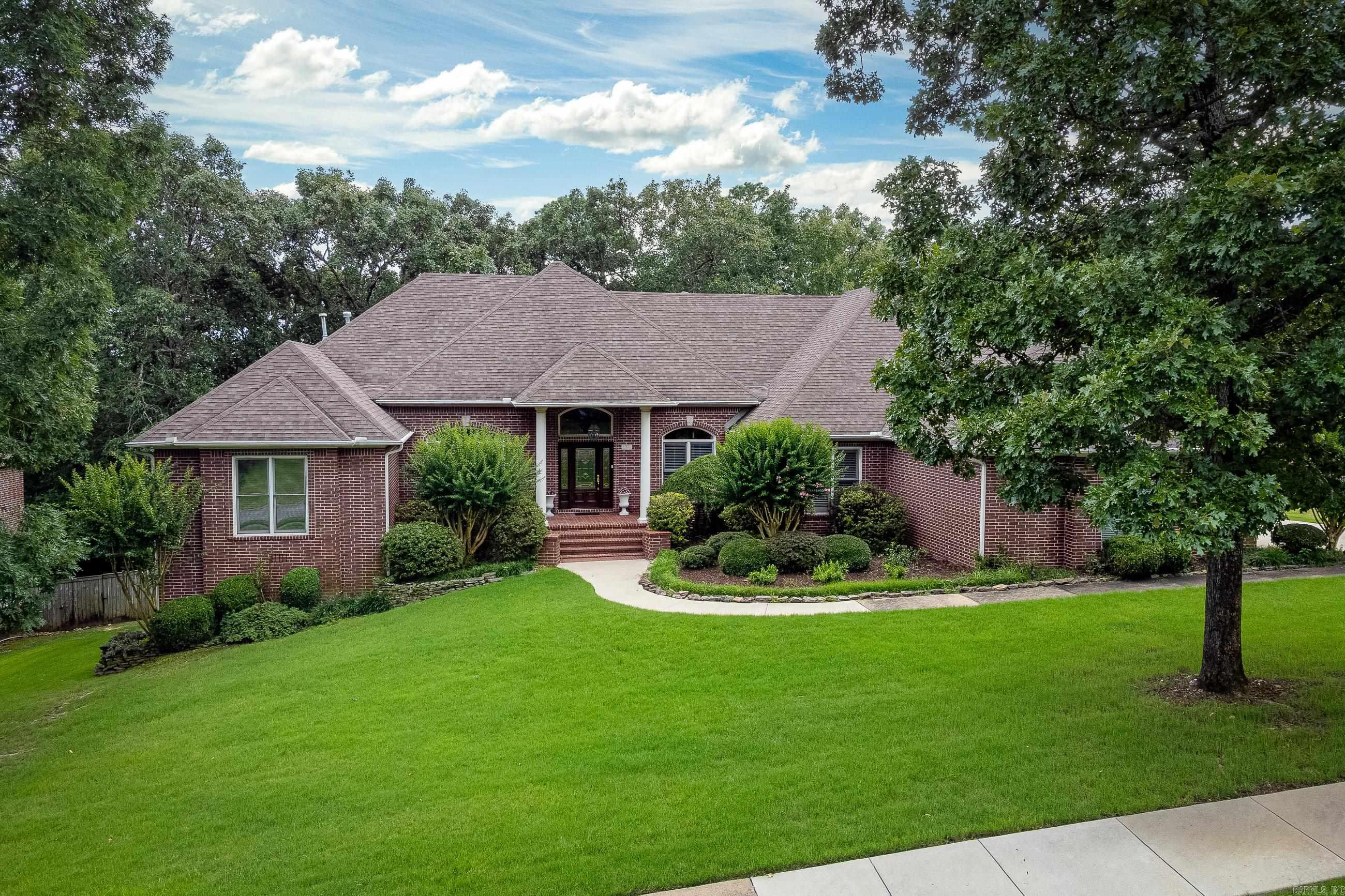 Lovely traditional family home on beautifully landscaped lot backing to green space. Awesome floor plan that lives like a one level with tall ceilings, HDWD floors and plenty of natural light, there is wonderful space for entertaining. Spacious eat-in kitchen with slab granite, center island & Stainless appliances. Formal Living, Dining & Den opening to 2 decks with seating overlooking yard.  Huge Primary suite with gas log FP sitting area, extra large spa bath & closet. Three nice sized guest bedrooms share hall bath as well as half bath.  Lower level with 5th bedroom en-suite, another living area and access to lower deck and backyard. Three car side load garage. Great storage. New HVAC, New Hot Water Heater, New Paint!  Come See!