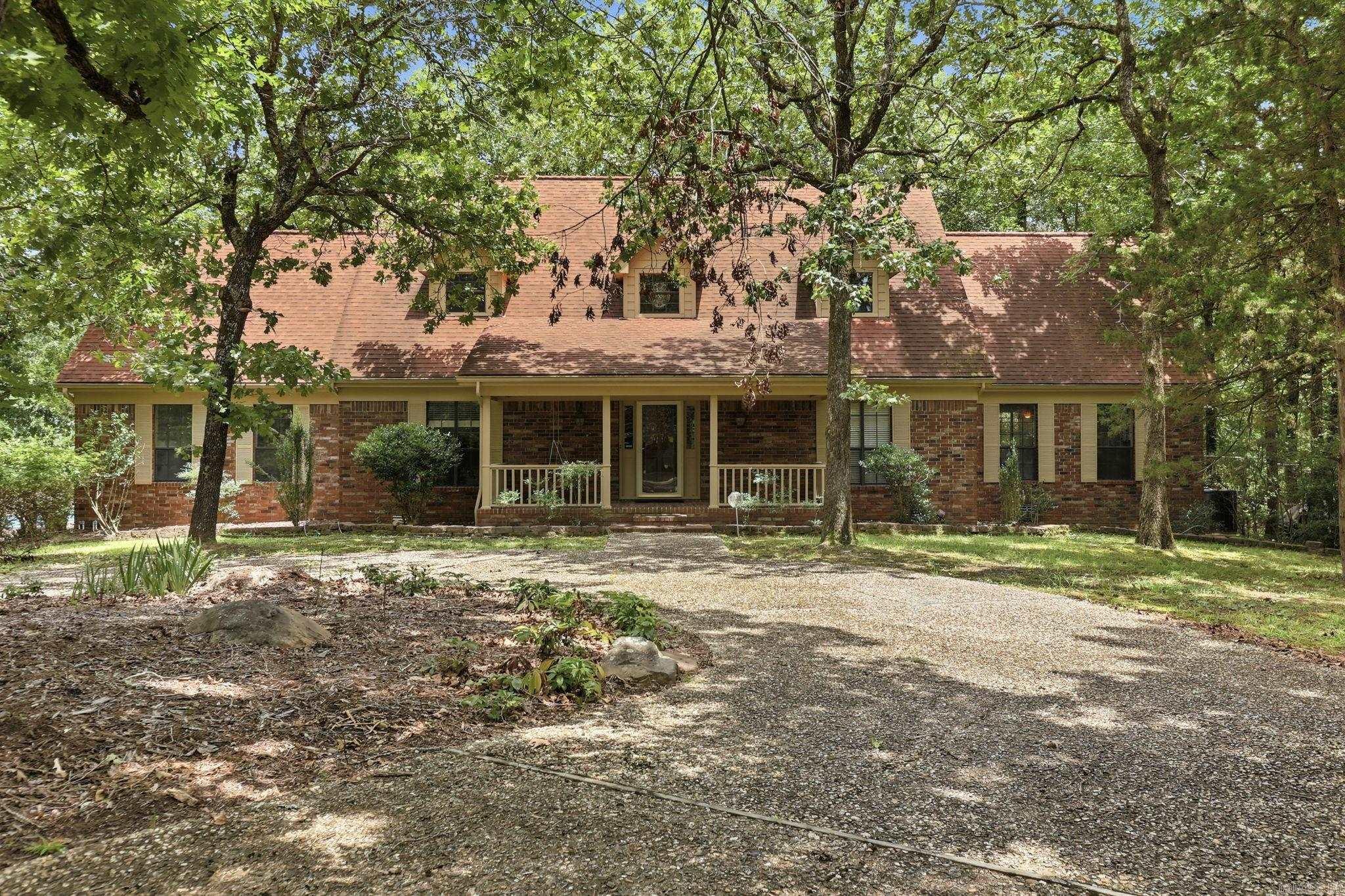 This is a rare opportunity to be in a perfect location!  Woodsong is a gated equestrian neighborhood just a ½ mile off Hwy 10, close to Chenal Shopping and dining and Lake Maumelle.  There is a community barn and gorgeous gazebo overlooking the community park and pond.  The home sits on 3.16 acres and has multiple water features, extensive landscaping, swimming pool, hot tub, sundeck, covered deck and so much more! Inside you will find 3 living areas, 2 fireplaces 4 bedrooms. The  Island kitchen with granite counters, double ovens, tiled backsplash is open to a bay window breakfast area and large hearth room.  You will find a cozy den with fireplace, wet bar and private covered deck.  3rd living space could be a formal Living room or expansive office. Formal Dining room.  Upstairs you will find a large primary suite with spacious primary bathroom, 3 closets, jetted tub, separate shower.  The 4th bedroom is huge and has an in suite half bath. The home has a gorgeous view out back of the incredible grounds and from your front porch you can see the fabulous community barn and horses grazing. Circle drive, 2 car garage. Agents see remarks!
