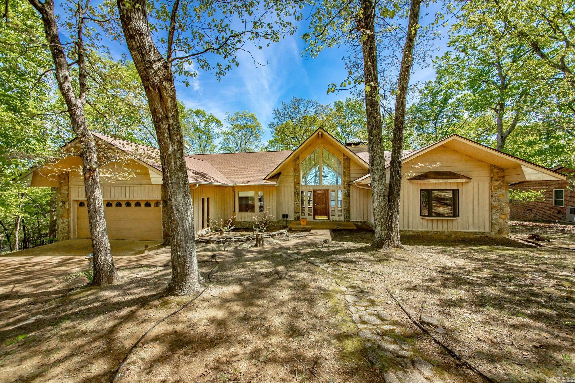 You will love this charming home in Diamond Bluff nestled in the woods with breathtaking views of Greers Ferry Lake!! The floor plan encompasses 3 roomy bedrooms, 3 bathrooms giving you 2,582sf of spacious elegance! The generously proportioned interior flows effortlessly from the open-plan living space to the private screened in porch and rear deck perfect for family gatherings! All of this situated in a convenient, friendly neighborhood. Nature and tranquility are calling your name, schedule a private tour today to see this lovely property!