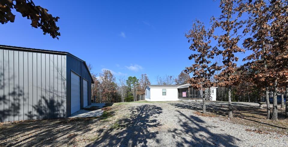 Beautiful 3-acre property on Wildlife Lane in Mount Ida, Arkansas. This well-maintained mobile home offers a surprisingly spacious interior with an open layout and split floor plan. Interior amenities include a pantry, walk-in closets, and a relaxing soaking tub. Enjoy outdoor living with a back deck, fenced backyard, and a screened front porch. The property also features a circle drive and an impressive 40' x 40' shop with dual 12' doors—ideal for storage, hobbies, RVs, or equipment. Located less than 5 miles from the crystal-clear waters of Lake Ouachita and just minutes from the Ouachita National Forest.