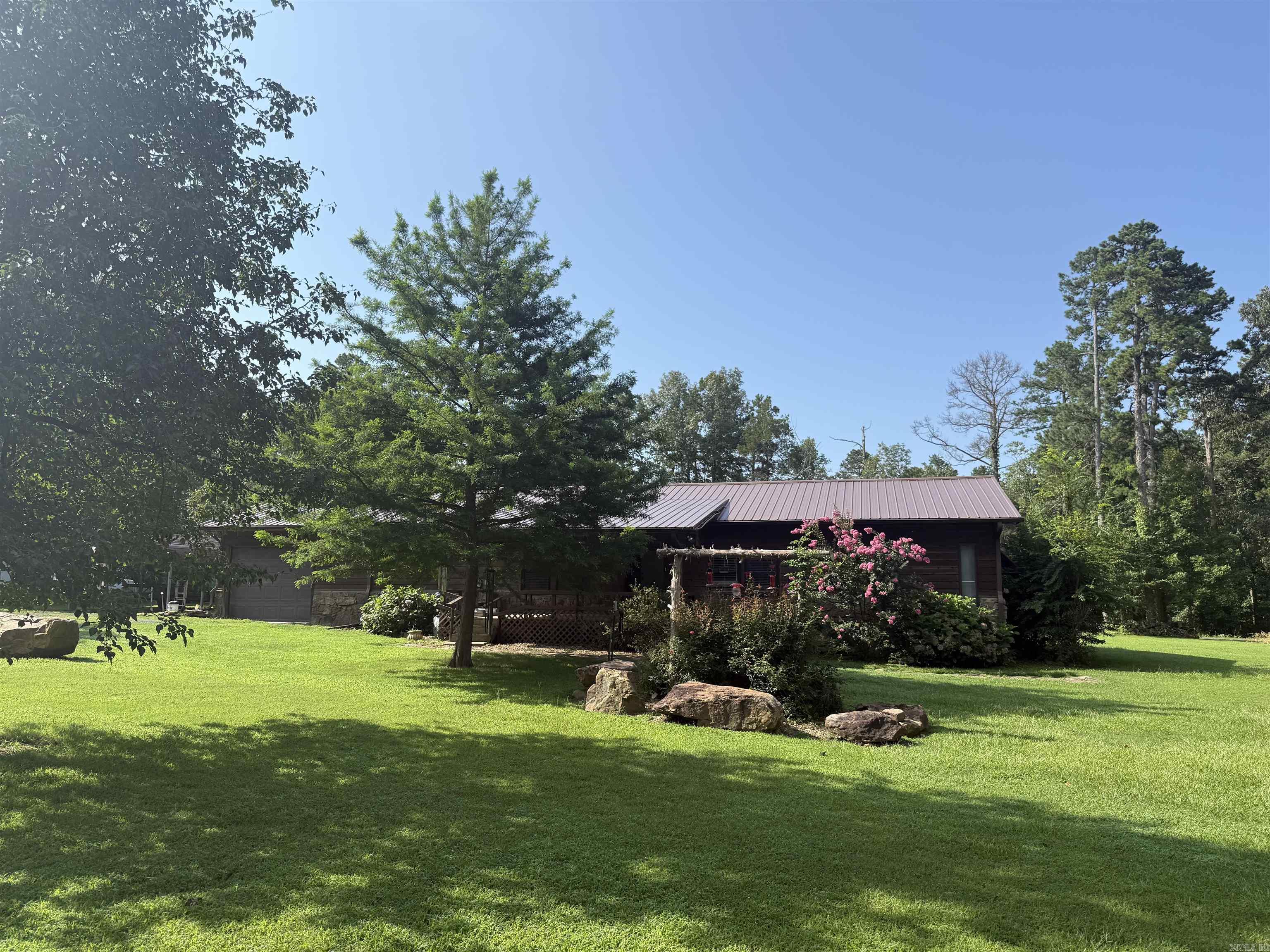 Spacious 3 bedroom and 2 bathroom cabin sitting on 1 acre awaits! Just 5 minutes from Sugar Loaf Marina and offers plenty of storage for your boat, golf cart, and side by side. The property features lots of outdoor space with a large back deck for grilling and enjoying relaxing evenings after a day on the lake. The home has a new metal roof and added large landscape rocks throughout the yard to give it a unique feel. Schedule your showing today!