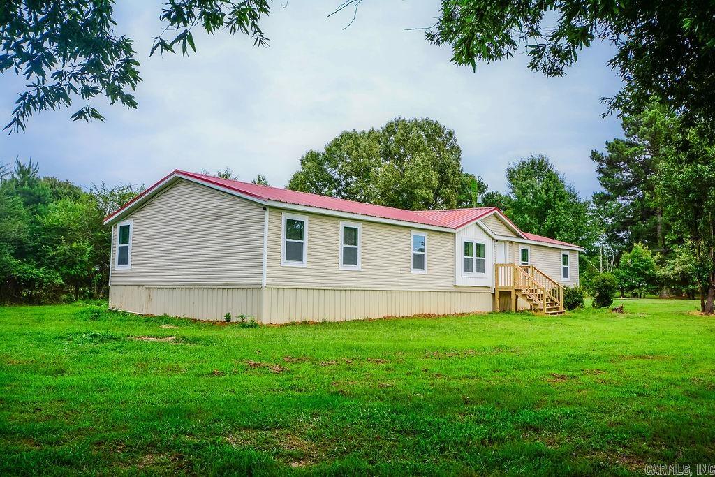Rarely do you find a home that offers this much space, this many updates, and approximately 1.5 acres to enjoy; with such an amazing price. This beautifully remodeled 5 bedroom, 2 bath home is the perfect blend of comfort, functionality, and peace of mind.  Step inside to discover fresh finishes throughout, including new cabinets, updated flooring, and new windows that bring in an abundance of natural light. The new HVAC system provides year-round comfort, while the durable metal roof adds long term value and low maintenance appeal. With five spacious bedrooms, there's plenty of room for a growing family, guests, a home office, or multi-generational living. Outside, you'll love the freedom that comes with acreage; whether you envision a garden, a shop, outdoor entertaining, or simply enjoying the extra room to breathe. For added peace of mind, the property also includes a storm shelter, giving you one more reason to feel right at home.  Move-in ready homes with acreage and major updates are becoming increasingly hard to find. If you've been searching for a property that truly checks all the boxes, this one deserves a place at the top of your list.