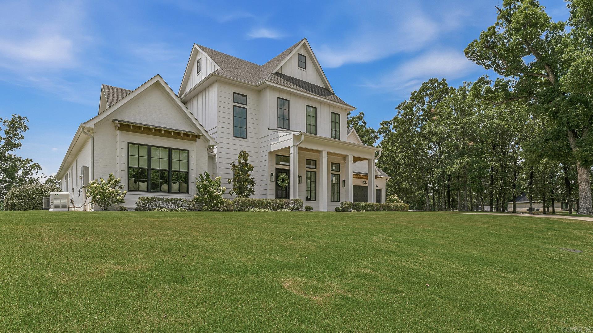 Welcome to this extraordinary custom-built Modern Farmhouse on 3 private acres. Featuring stunning brick and Hardie Board exterior, this remarkable home offers combines elegance, comfort, technology and entertainment. Step inside to the soaring 12 ft ceilings and 16 ft vaulted master suite, cast stone fireplaces and white oak flooring throughout. Custom cabinetry, high end appliances and premium fixtures boast the true elegance of this home. The luxurious primary retreat features a spa-inspired marble bathroom with double walk-in shower, soaking tub and expansive walk-in closet. Entertain effortlessly with a chef's dream kitchen which flows to the outdoor kitchen and living space, with phantom screens to create a comfortable retreat. The fully equipped in home gym, FEMA rated safe room and automated Theatre Room are just a few of the amazing amenities offered. Designed with peace of mind as a priority with state-of-the-art security and alarm thru the Control4 Home Automation System.
