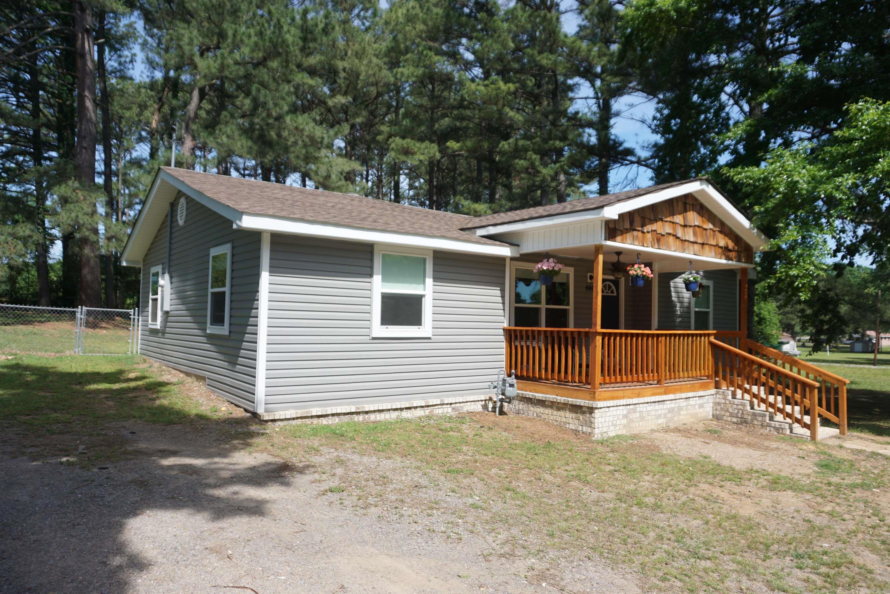 Beautiful remodel in Bald Knob close to the School. Large fenced in back yard with storage shed. The house has 4 bedrooms with nice closets, lots of windows and 2 full bathrooms. Both bathrooms have new bathtubs/showers and 1 is a jetted tub. Both have pretty vanities with nice faucets and mirrors. The large eat in kitchen has tons of cabinets and countertop space and nice Stainless appliances and the French door refrigerator will convey. There is a beautiful high arc faucet with pull out sprayer at the kitchen sink and the laundry room is very large and is located off the kitchen with built in shelving and the back door goes out to a wonderful wrap around curved back porch that has built in bench seating. There is a continuous natural gas hot water heater that services this house, the floors are waterproof LVP and the roof is new with 50 year architectural shingles. The seller went all out with the light fixtures and they have dimmers and multiple light choices in a lot of the rooms, even the front porch has the porch light plus can lights plus a ceiling fan all with different switch options. Just so much thought was put into the finishes on this one. Go take a look !