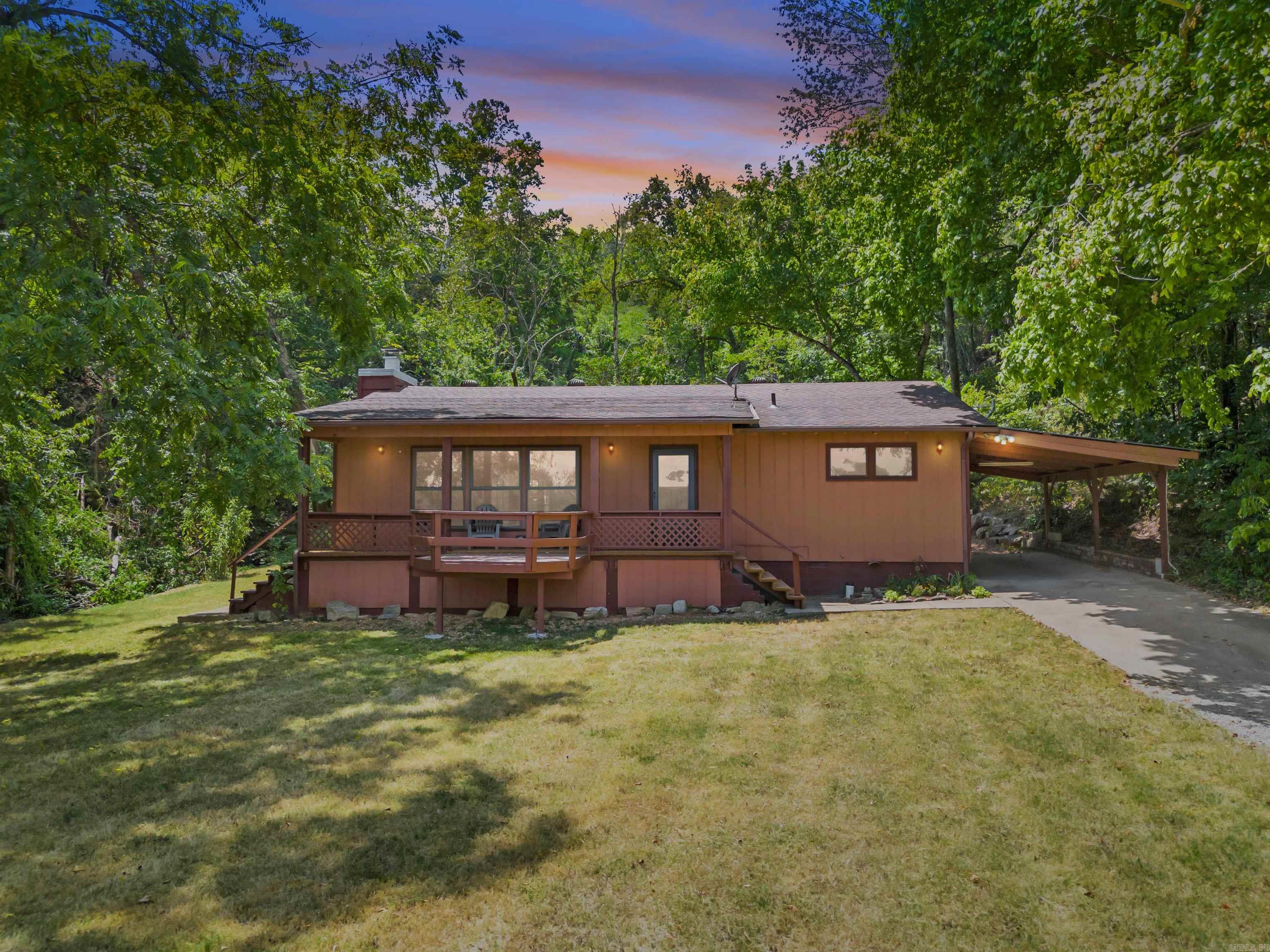 Tucked away in a truly special setting, this charming 2-bedroom, 1-bath cabin on 4.18 acres offers the perfect blend of privacy, nature, and modern comfort. Backing directly to the National Forest, this secluded retreat is nestled at the base of the mountain overlooking the White River valley, just 3/10 of a mile from a boat launch on the White River, with a Year round spring fed creek, walnut, peach, and pear trees, gardens, the property is alive with abundant deer and wildlife, creating a peaceful, postcard-worthy atmosphere. Inside, the cabin features all new kitchen appliances, new luxury vinyl plank flooring in the open concept living room and kitchen, and a beautiful native stone wood-burning fireplace that anchors the living space. Enjoy the outdoors from the screened-in covered patio or the front porch with sweeping countryside views. Room for additional buildings/homes. This property has a carport, RV parking with electric hook up, fiber-optic internet availability, and an excellent area for a garden. Just minutes from the town of Norfork.