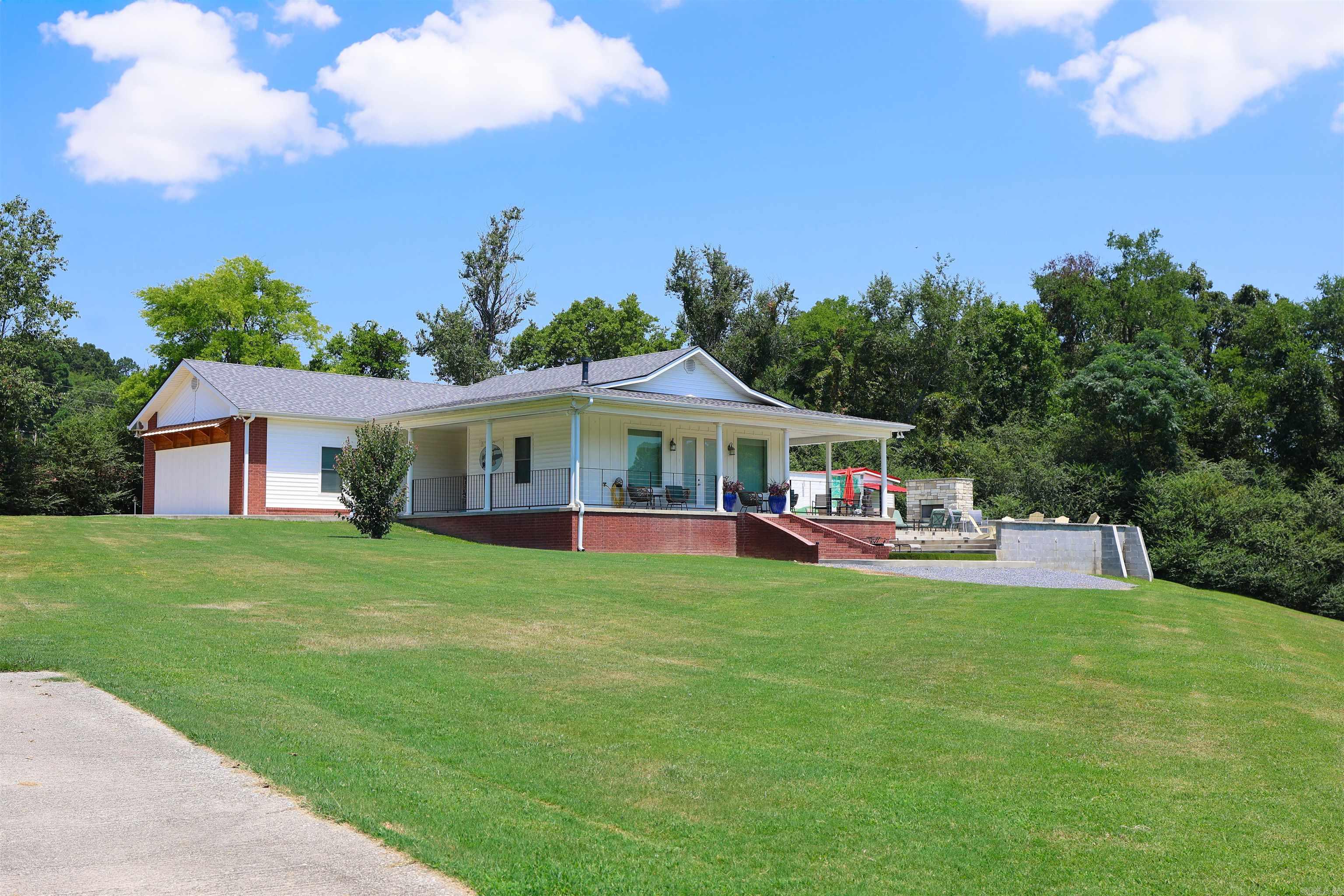 Welcome to Crawford's Lookout! Escape to the banks of the Caddo River with this exceptional riverfront property. Currently operating as a successful Airbnb and designed for both relaxation and investment potential. Situated on approximately 3.1 acres, this custom-built home was completed in 2010 with durable steel-frame construction, offering lasting quality and peace of mind. With 4 spacious bedrooms and 3 full bathrooms, the home provides plenty of room for family gatherings, vacation guests, or full-time living. The open, inviting layout is complemented by expansive windows that capture the natural beauty surrounding the property. The home comes fully furnished allowing for immediate enjoyment of your riverfront investment. Step outside to an oversized patio and porch containing two fireplaces perfect for entertaining, dining, or simply enjoying the peaceful riverfront setting. The property also has a 35 amp & 50 amp RV spot. The property boasts approximately 300 ft of easy-access, slightly sloped frontage on the Caddo River, making it ideal for swimming, fishing, kayaking, or relaxing by the water. This one-of-a-kind riverfront home offers it all!