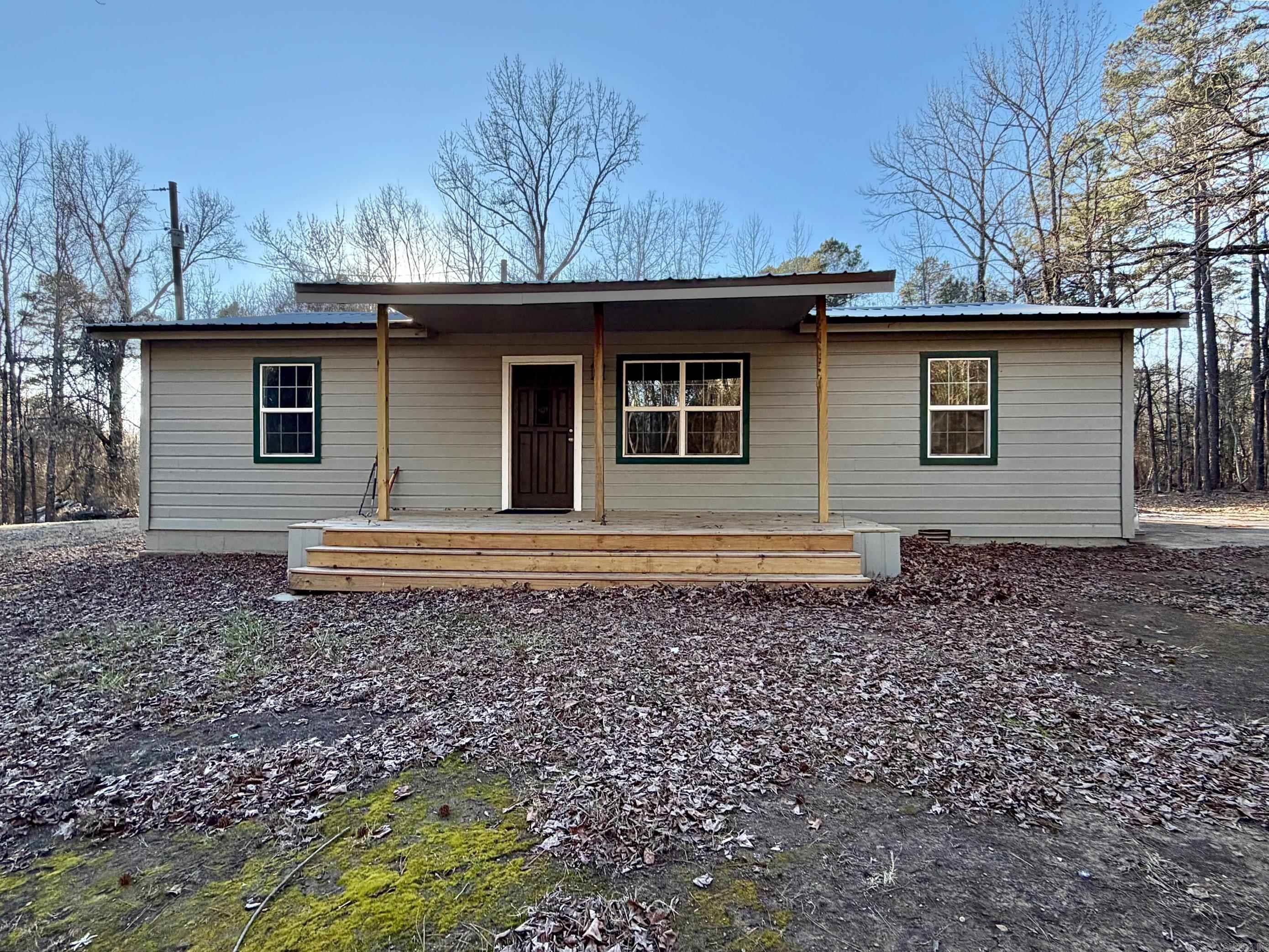 Welcome to 138 Anderson Lane in Delaware — a fully remodeled 3-bedroom, 2-bath home offering approximately 1,300 sq ft of updated living space on roughly 3 secluded acres. This peaceful country retreat features a new metal roof, new flooring, fresh paint, new windows, updated lighting, new tubs, modern fixtures, and a tankless water heater for added efficiency and comfort. Enjoy quiet mornings on the covered porch surrounded by serene views and wide-open space. With plenty of room to garden, explore, or simply unwind, this property is perfect for those seeking privacy and country living. Located just minutes from outdoor recreation at Lake Dardanelle and the popular Lion's Den Golf Course, you’ll have the best of nature and golf right at your doorstep. Modern updates, peaceful setting, and move-in ready — don’t miss this opportunity!