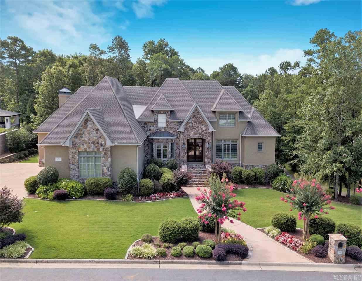 CUSTOM BUILD IN THE PERFECT SETTING! Inside hosts beautiful detailing and a wonderful layout. Great house for entertaining - both inside and out.  Gourmet kitchen opens to spacious Hearth/Den and breakfast area. Main level Master suite is lovely and opens onto the the upper patio (which runs the length of the house)  You get all the rooms you need - Lower level w/game room full bar area, exercise room & full bath. Upstairs has 2 large bedrooms, 2 baths, loft area & Rec Room.  BEAUTIFUL HOME! See Virt. Tour