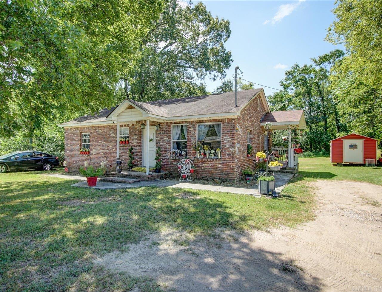 Brick Bungalow on Double Lot | Buildable Bonus Parcel | Central Location  Updated 3-bedroom, 2-bath brick home situated on a double lot in a convenient central location. This well-maintained bungalow features hardwood floors, new stainless steel kitchen appliances including refrigerator, stove, and dishwasher, and a stackable washer and dryer that convey.  The home offers covered front and back porches and a neatly kept yard, providing comfortable indoor and outdoor living space. A newly added storage building adds functionality for tools, equipment, or additional storage needs.  The additional lot at 303 Dexter is cleared and may offer potential for future construction, subject to city approval and zoning requirements. This bonus parcel provides flexibility for expansion, additional development, or long-term investment.  Move-in ready brick home with recent updates, extra land, and options for future use—all in a centrally located setting.  There is a train that goes by once a week on Wednesday morning at 8am and goes back at 11am.