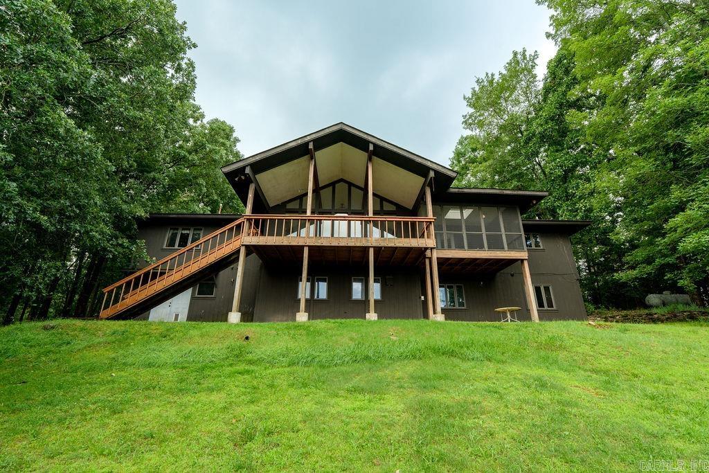 If you've been looking for room to spread out, a lake view, and a little bit of country living, this is it! Sitting on 10 beautiful acres, this two story home offers incredible views of Greers Ferry Lake from the large back deck, which was newly built in 2025. The wall of windows in the living room lets you enjoy the view year round and fills the home with natural light. Inside you'll find two separate living areas, one upstairs and one downstairs, giving everyone plenty of space to relax, entertain, or host guests. Step outside and enjoy the screened in porch, soak in the hot tub after a long day, or spend time working on projects in the workshop. Horse lovers will appreciate the 2 stall barn and acreage, while outdoor enthusiasts will love being just minutes from Eden Isle Marina, Heber Springs Parks & Recreation baseball fields, golf, restaurants, and all that Greers Ferry Lake has to offer. Whether you're looking for a full time home, weekend getaway, or a place for the whole family to gather, this property has the space, views, and location to make it something special.