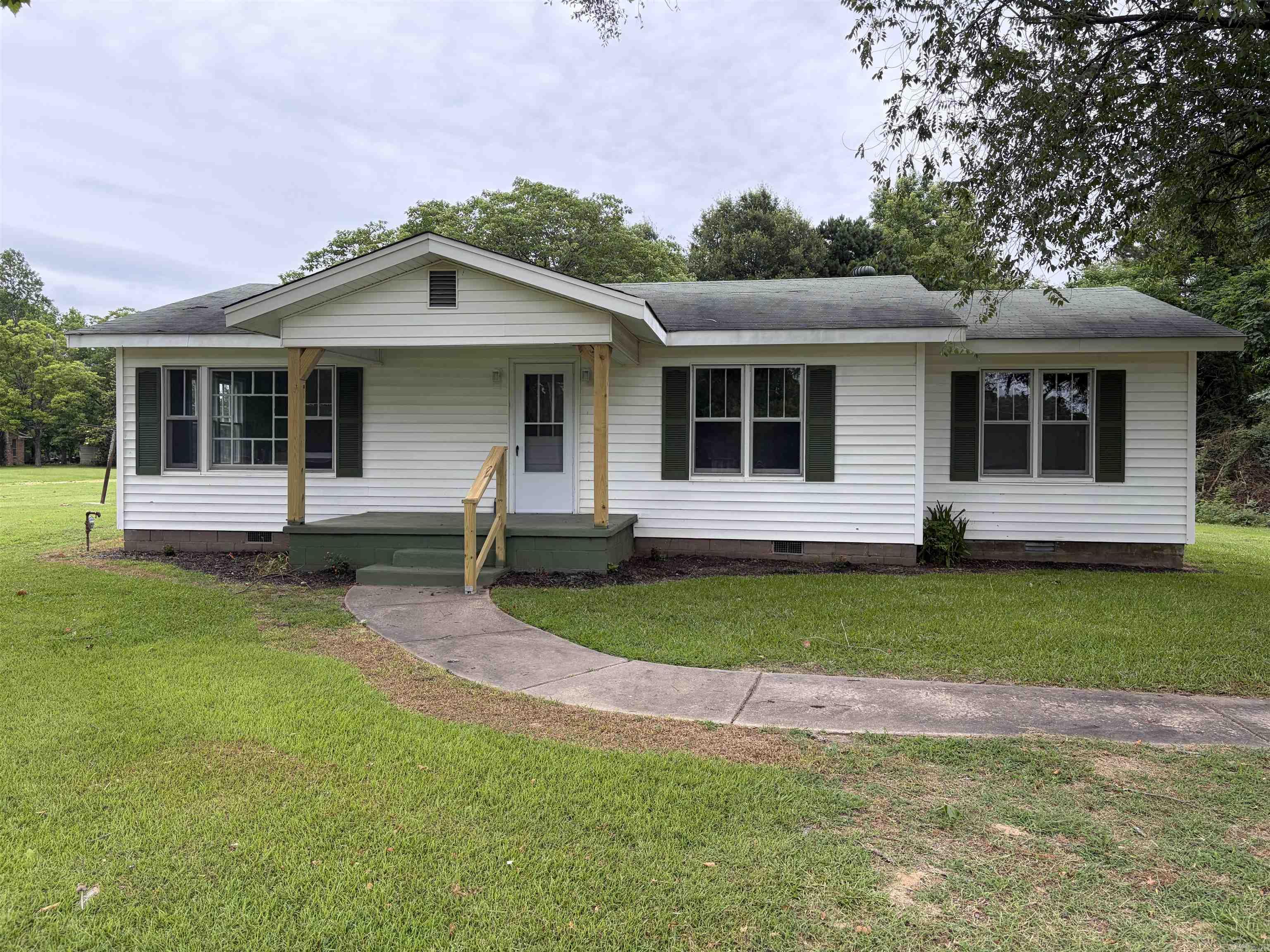 Charming move in ready 3 bedroom 2 bath ** Large kitchen ** New ch/ca** New flooring ** fresh paint ** covered back porch ** mobile home on property to convey at no value but is currently rented for $400 per month ** could be commercial the possibilities are endless **