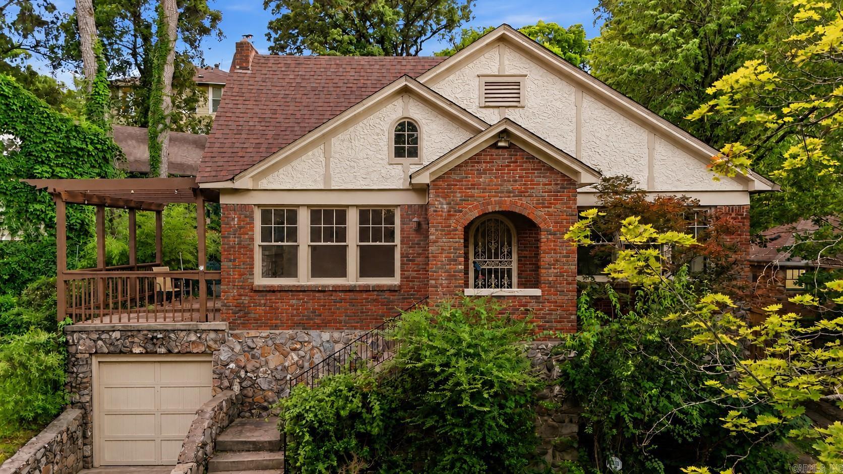 This Historic Hillcrest home is located on a quiet cul-de-sac w/beautiful treetop views & seasonal view of Arkansas River bluffs. An elevated patio perfectly located w/access off the living room & master bedroom provides an ideal setting for relaxing evenings & outdoor entertaining. Original architectural elements including doors w/rich wood grain detail, arched doorways, wall sconces, & native quartz fireplace provide historic charm and create a warm, inviting home. Outdoor storage/workshop.