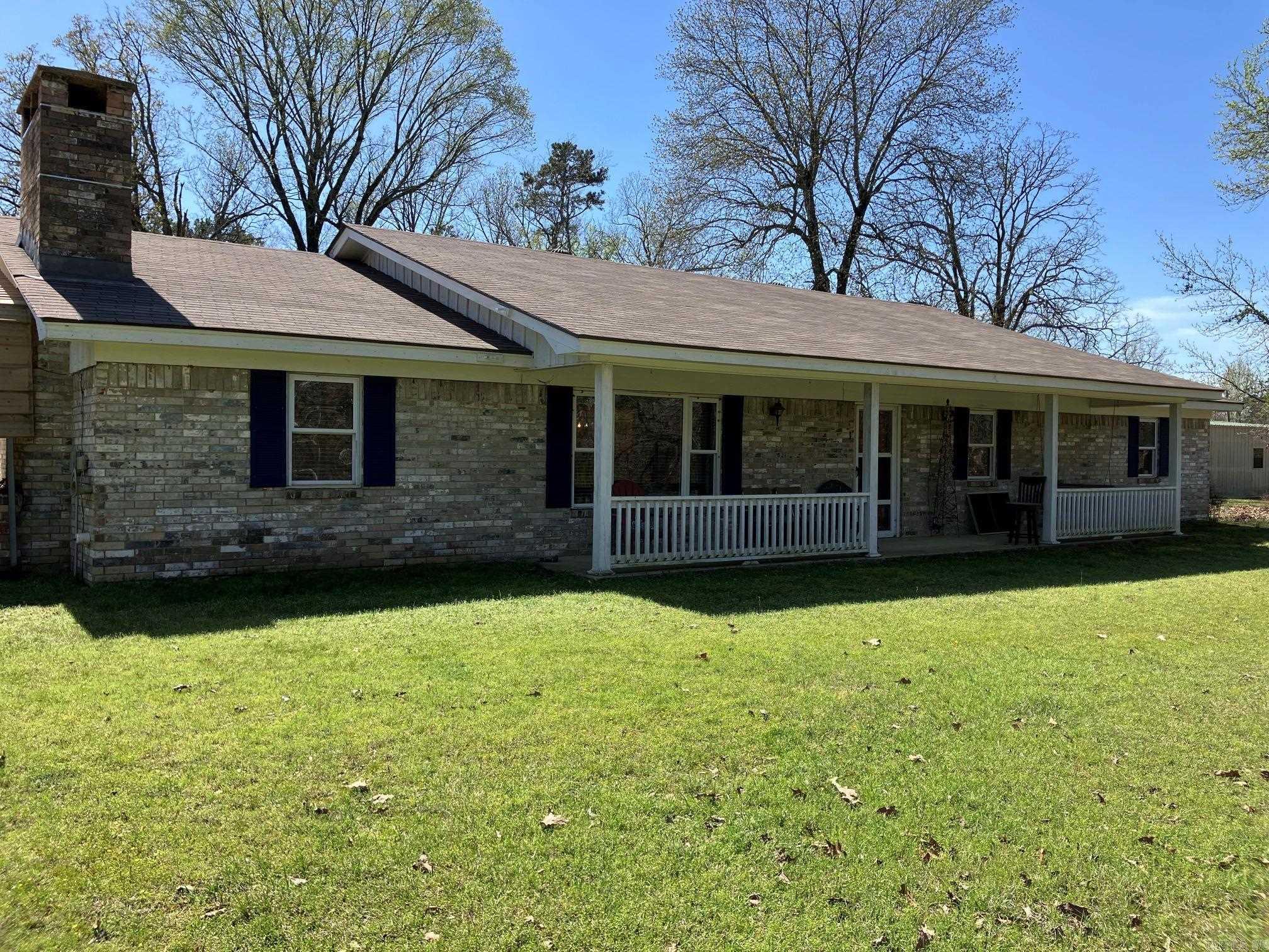 Open House Rescheduled to Saturday June 6th 2- 4pm.  Peaceful Country Living, imagine winding thru the trees coming home to your new house! Convenient both to town and De Queen Lake (3 miles in either direction).  Lovely brick home on a slab foundation is ready to move-in. Extra Large Kitchen overlooking a lovely dining room and a Large Living room with a brick Fireplace w/blower.  Luxury vinyl plank flooring, tile in the bathrooms and brand new carpet in the bedrooms.  Interior boasts fresh paint in a nice neutral theme just ready for your color pops! Both bathrooms have been remodeled in the last 4 years.  The second bath has an extra large tile shower. Closets are extra deep. Outside of the home there is a lovely covered front porch and a big covered back porch to take advantage of the views in both directions.  Nice large brick well house / storage building, 2-car carport and a shop/barn with concrete floors. Property also shares a stocked pond with the neighbor, and has lovely trees including two huge pear trees along with cleared spaces for gardening or livestock.  Roof new in 2022. A setting like this is hard to find anymore!