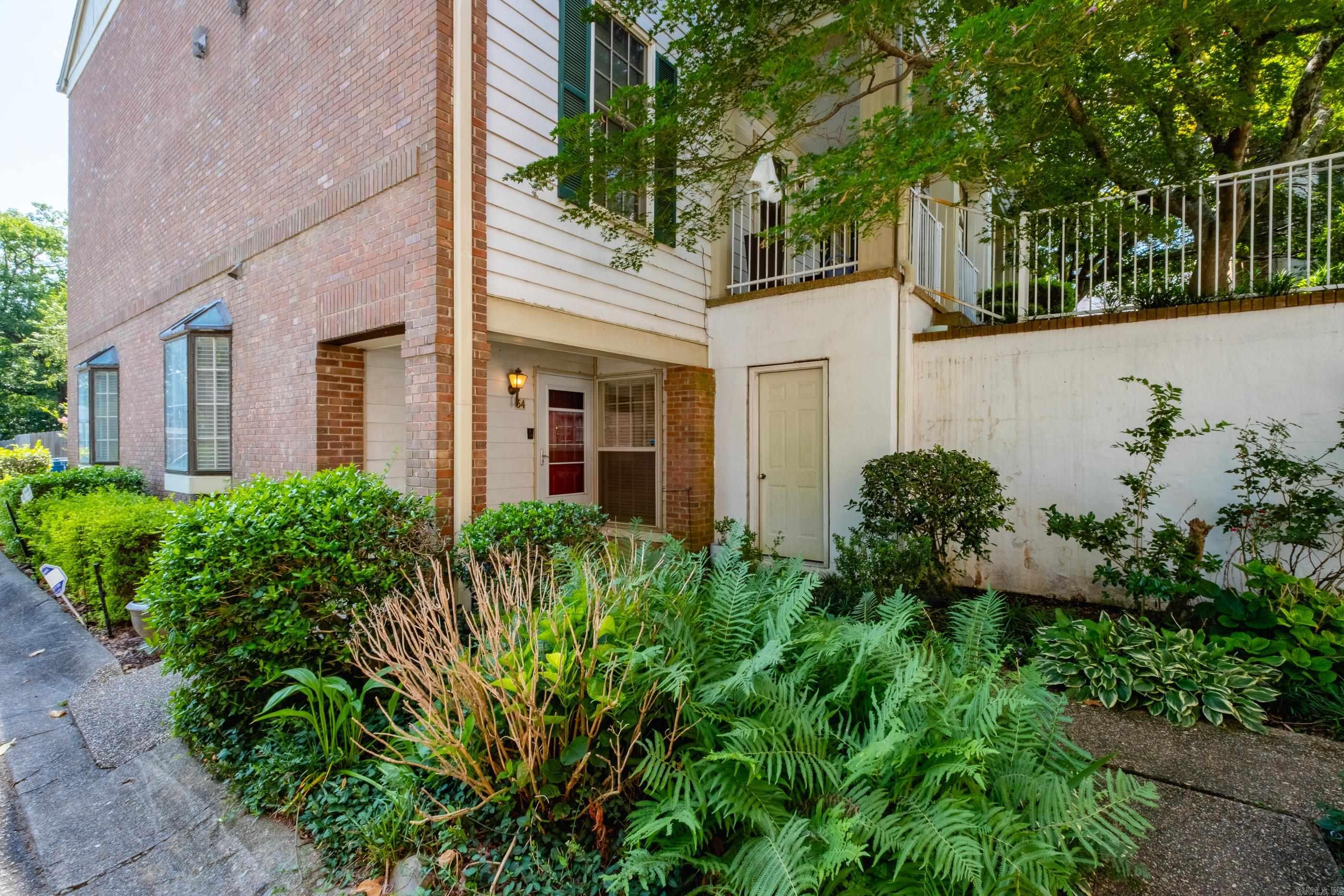 Incredible condo conveniently located in the heart of Hillcrest/Midtown, just minutes from UAMS, St. Vincents, shopping, dining and entertainment! This lower/main level Phases II condo offers the convenience of assigned parking just steps from your front door, with the community swimming pool also only steps away. Freshly updated with all-new flooring and paint throughout. The spacious living and dining area is filled with natural light and features a cozy wood burning fireplace with gas starter and wet bar - perfect for entertaining. The kitchen offers granite countertops, gas range and plenty of storage. The primary suite includes a walk in closet, bathroom with double vanity, walk in shower oversized soaking tub and a conveniently located laundry closet. The guest bedroom features its own en suite half bath.  Enjoy the enclosed back porch with a large storage room and direct access outside - ideal for plants, morning coffee or relaxing in the evenings. A wonderful opportunity to enjoy low maintenance living in one of Little Rock's most convenient locations!